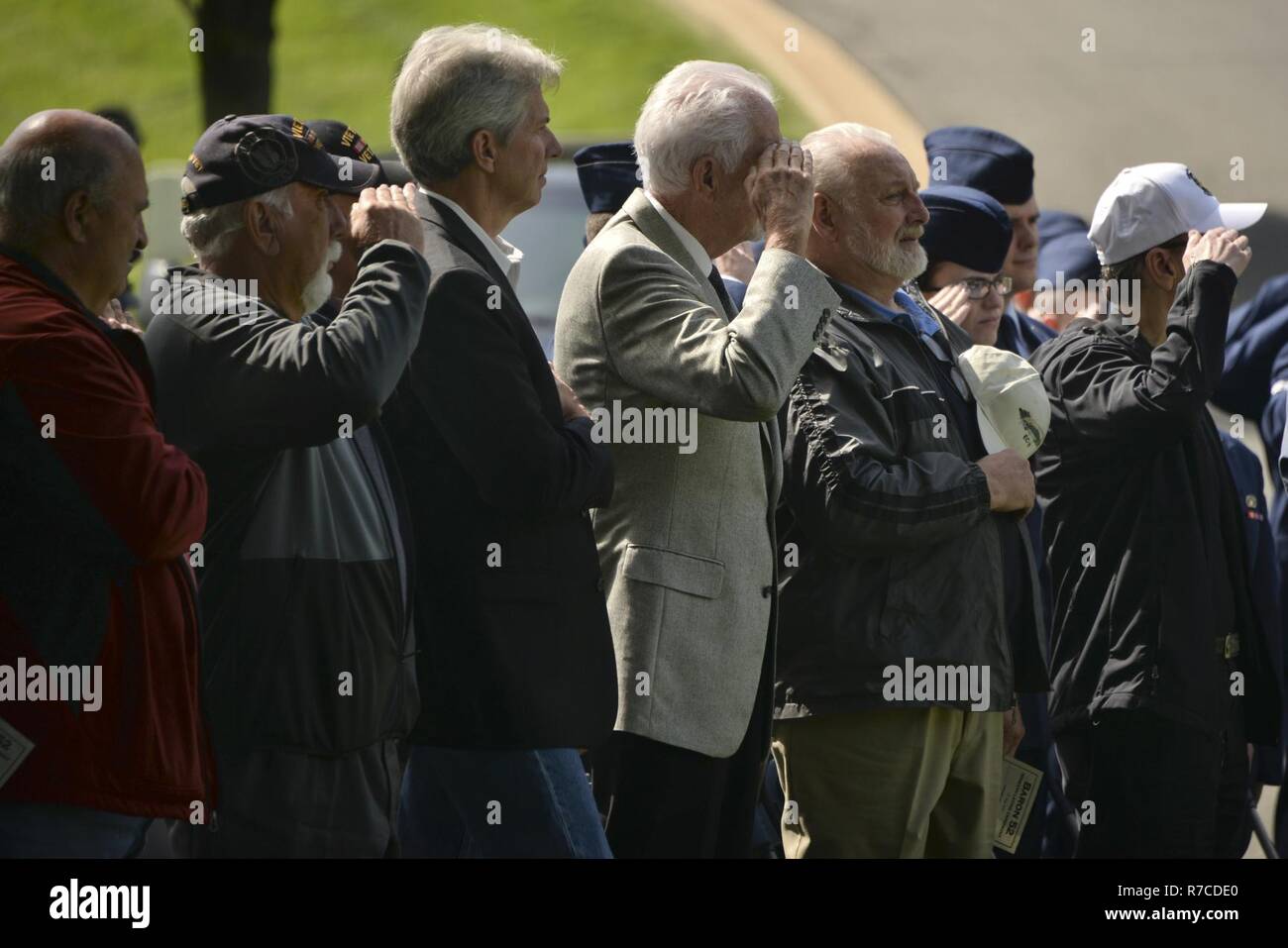 U.S. Air Force Vietnam Veterans salute during the playing of the national anthem prior to the BARON 52 wreath laying ceremony May 10, 2017. Stock Photo