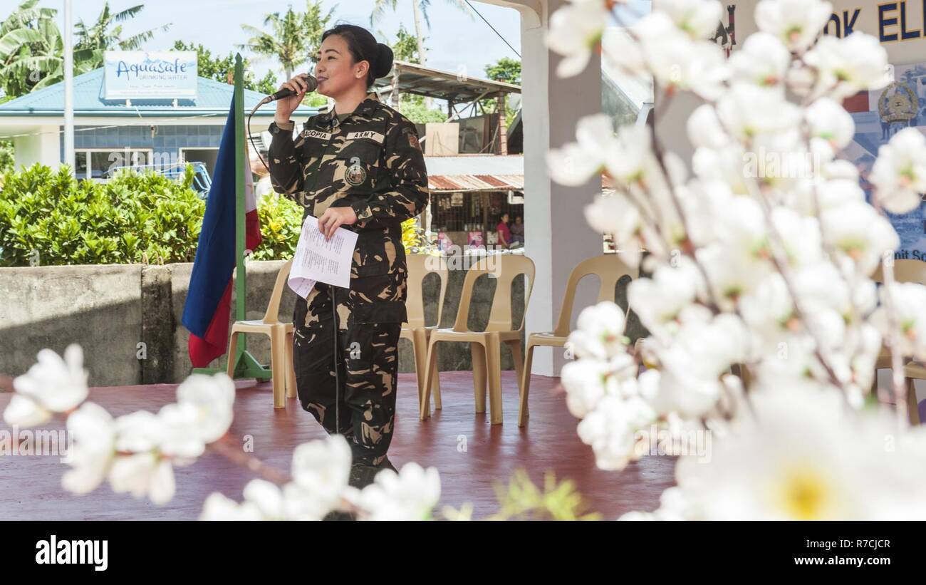 Philippine Army Pfc. Donna B. Macopia performs at a dedication ceremony during Balikatan 2017 in Guiuan, Eastern Samar, May 16, 2017. Armed Forces of the Philippines and U.S. military engineers worked together to build new classrooms for students at Surok Elementary School. Balikatan is an annual U.S.-Philippine bilateral military exercise focused on a variety of missions, including humanitarian assistance and disaster relief, counterterrorism, and other combined military operations. Stock Photo