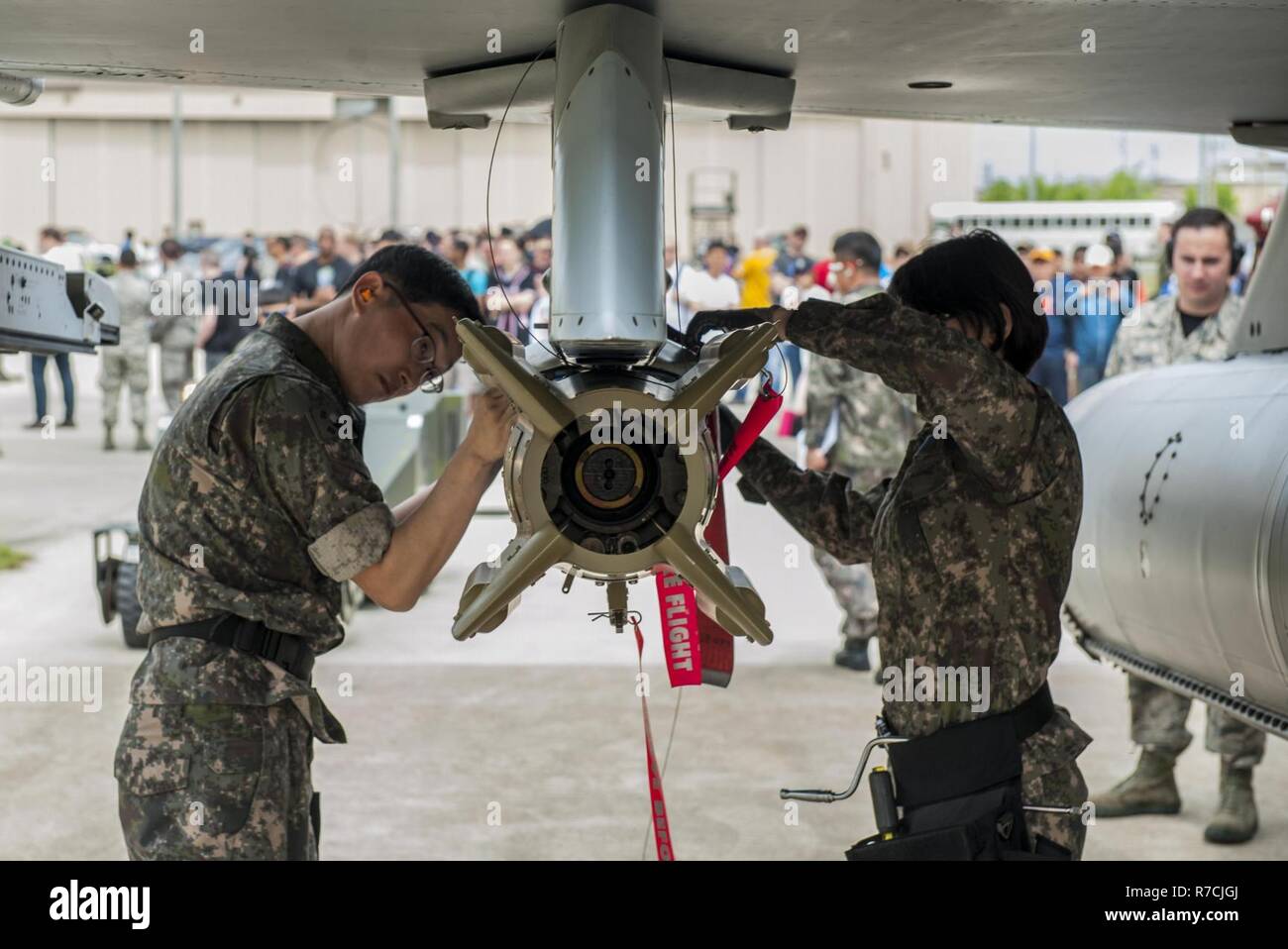 Republic of Korea Air Force airmen secure a bomb to an F-16 Fighting Falcon  during the 2017 annual weapons load crew competition at Kunsan Air Base, Republic  of Korea, May 13, 2017.