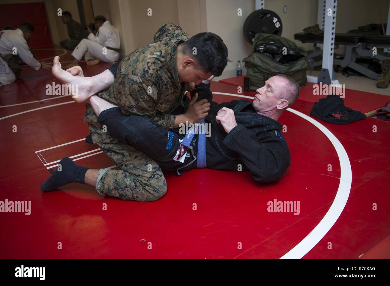 U.S. Marines practice Brazilian Jujitsu grappling techniques during a Martial Arts Instructors Course (MAIC) at Yale Hall, Marine Corps Base Quantico, Va., May 11, 2017. The MAIC is a three week long course that puts applicants through rigorous training designed to instill teamwork and develop leadership abilities necessary for a Marine Corps Martial Arts Program instructor to teach classes. Stock Photo