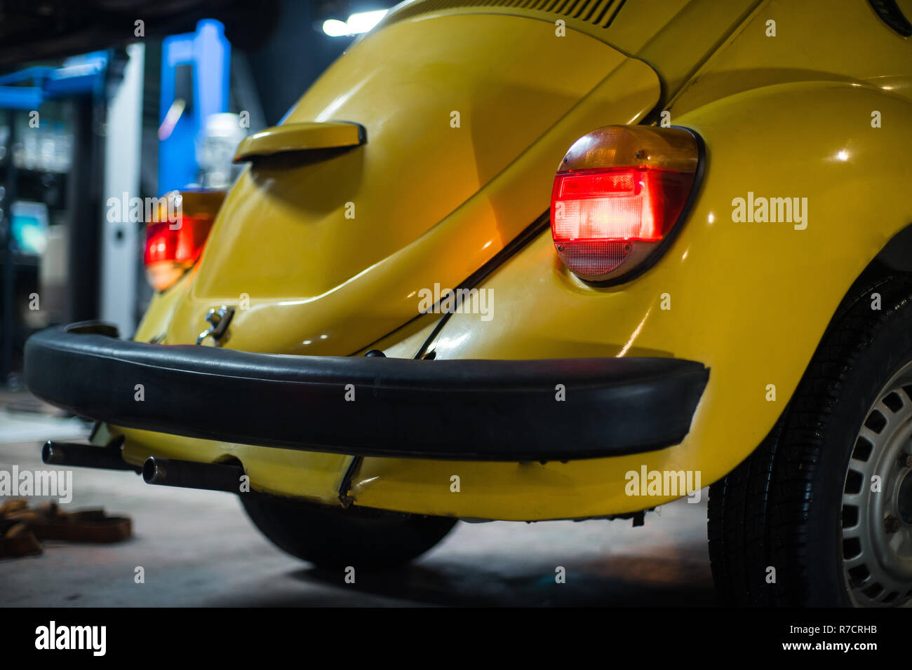 Close up of yellow classic car in workshop interior Stock Photo