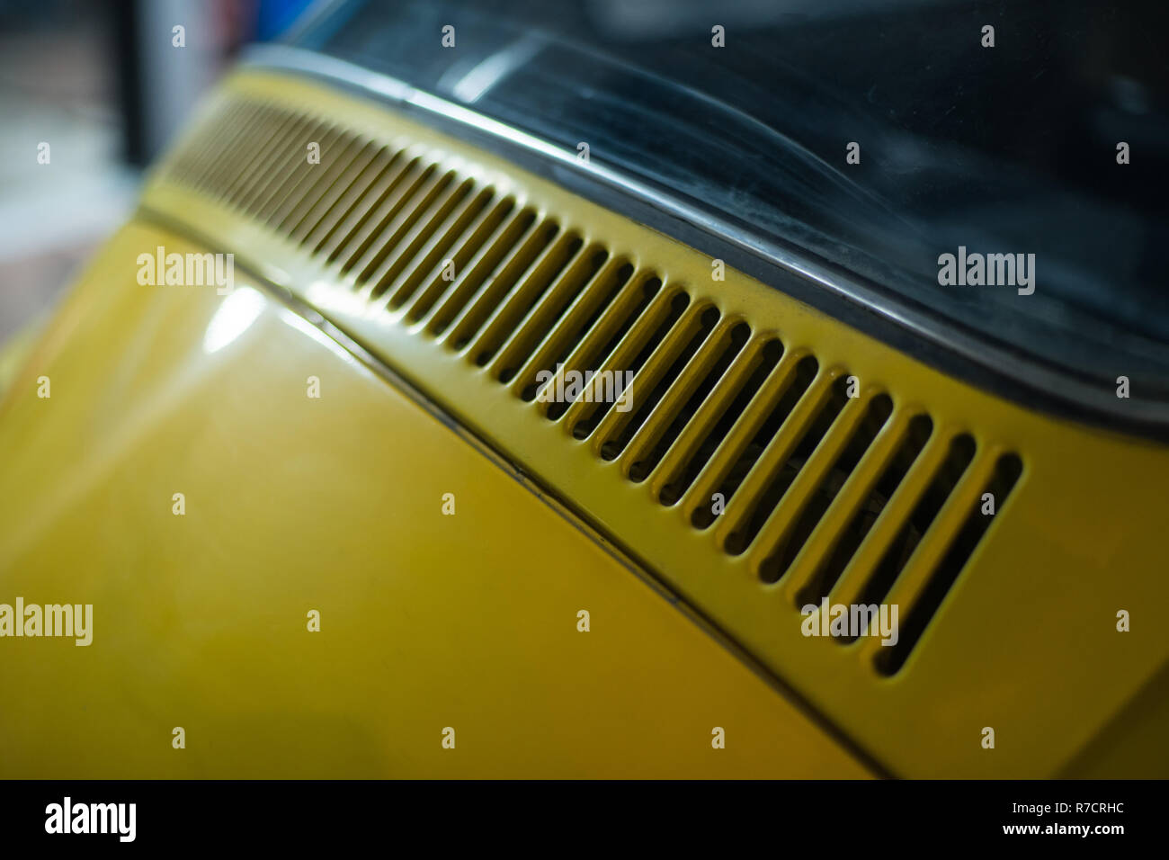 Close up of yellow classic car in workshop interior Stock Photo