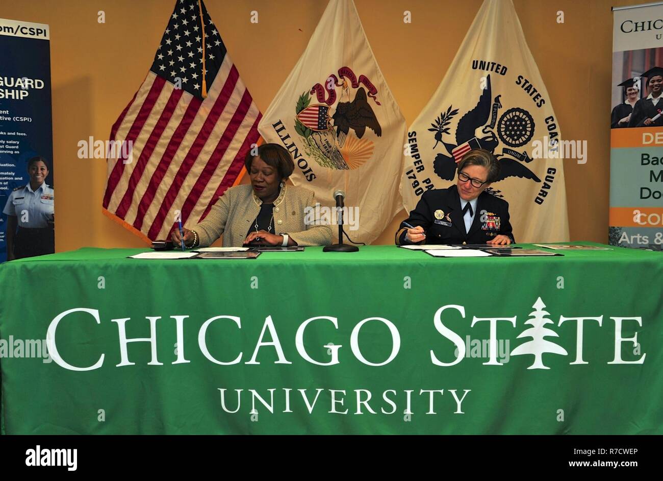 Rear Adm. Joanna Nunan, commander, Ninth Coast Guard District, and Zaldwaynaka Scott, Esq., president of Chicago State University, sign a Memorandum of Agreement during a ceremony at the university, November 30, 2018. The initiative, part of the Coast Guard's Minority Serving Institution Partnership Program, creates a partnership focused on increasing diversity within the Coast Guard's officer corps while providing scholarship and research opportunities for students. Stock Photo