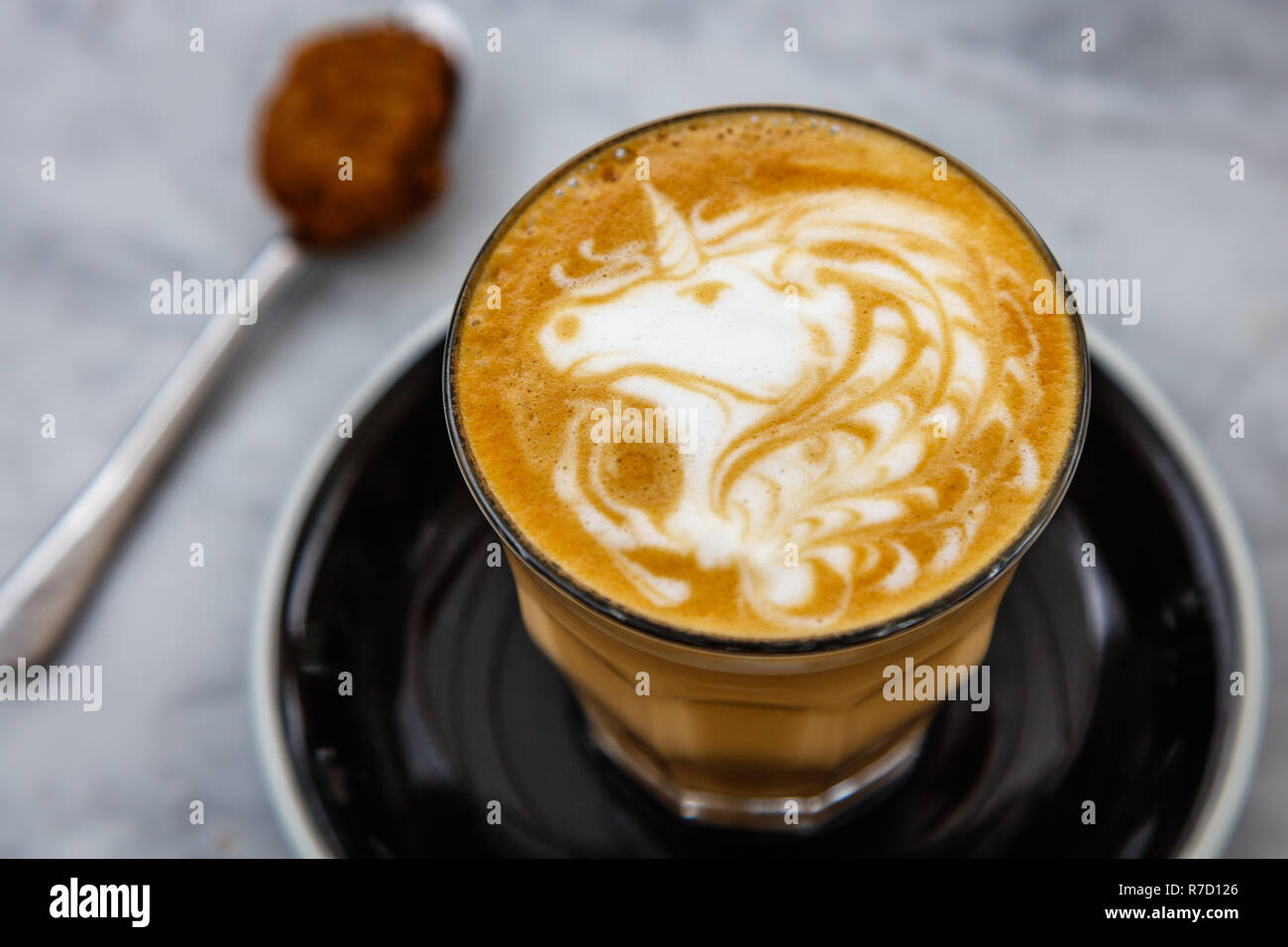 Cup of coffee latte with unicorn latte art on a while table Stock Photo -  Alamy