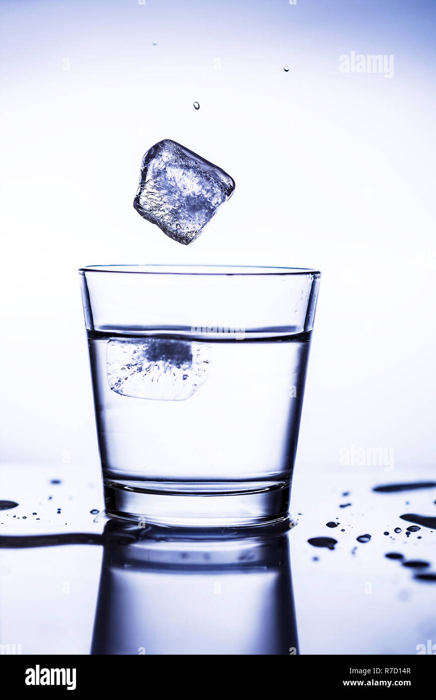 Splash ice cubes in a water glass Stock Photo - Alamy