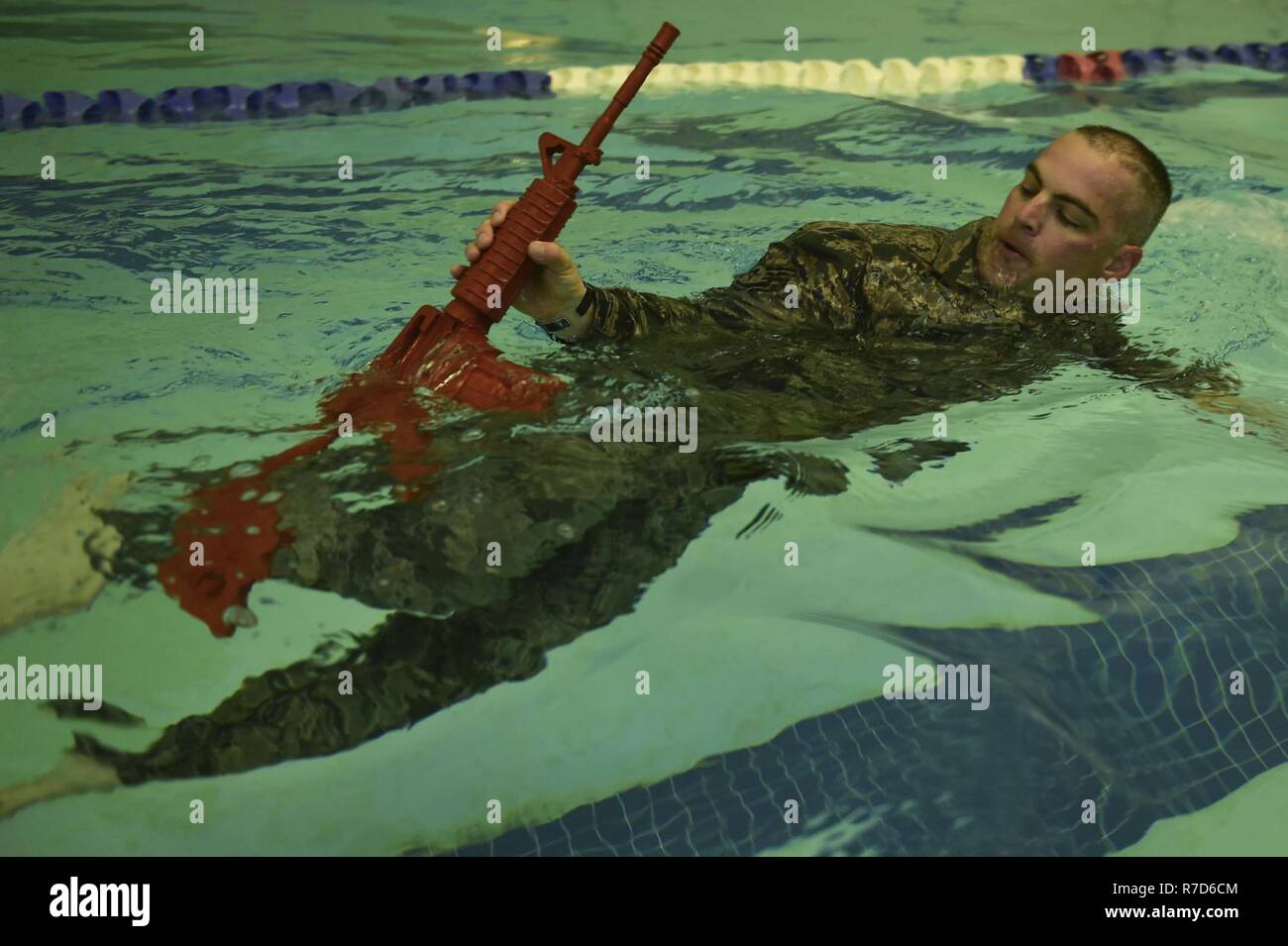 U.S. Air Force Tech. Sgt. George Daggett, 633rd Security Forces Squadron swing shift flight chief, performs a recovery swim during a training evolution at Joint Base Langley-Eustis, Va., April 28, 2017. The 633rd SFS Emergency Services Team conducted a test trial for a course future candidates will have to accomplish in order to join the EST ranks. Stock Photo