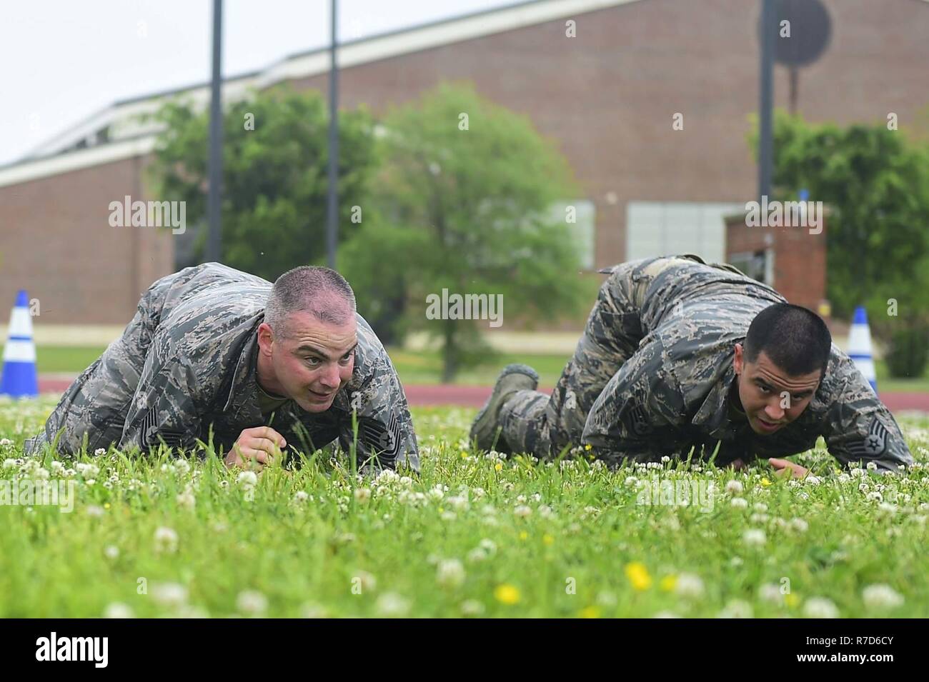 Members of the 633rd Security Forces Squadron Emergency Services Team perform a high crawl during a modified Marine Combat Physical Test at Joint Base Langley-Eustis, Va., April 28, 2017. The team provide services equal to a civilian police SWAT (Special Weapons and tactics) Team , to the installation and train to handle hostage and barricaded suspect situations. Stock Photo