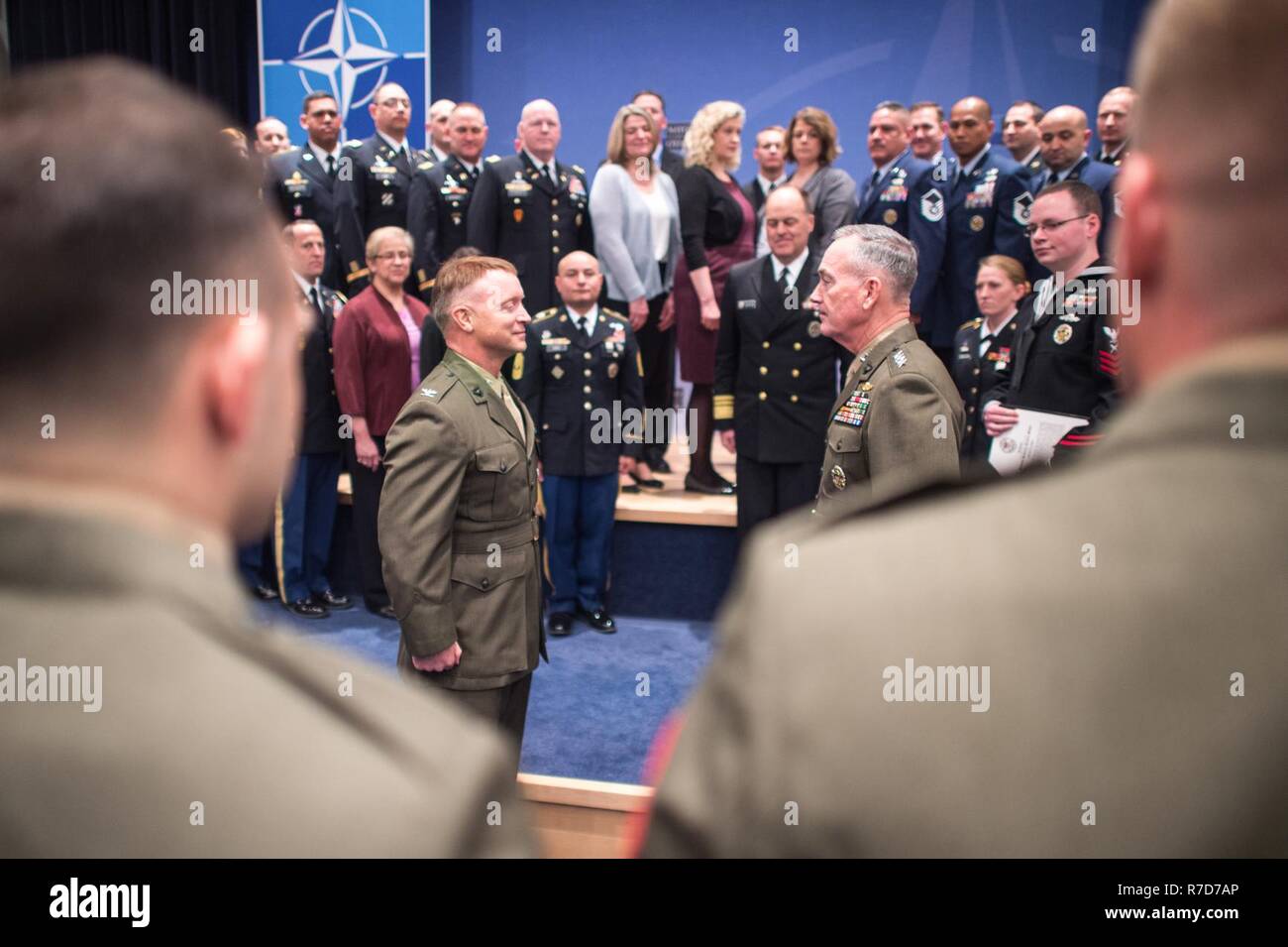 U.S. Marine Corps Gen. Joseph F. Dunford, Jr., chairman of the Joint Chiefs of Staff, participates in an award ceremony for U.S. Marine Col. Philippe ‘Boz’ Rogers, U.S. Military Delegation to the North Atlantic Treaty Organization (NATO) Chief of Staff, during a Military Committee in Chiefs of Defense (MC/CS) Session at NATO Headquarters, May 17, 2017. The Chiefs of Defense meet to discuss Afghanistan, countering terrorism and other NATO operations and missions to provide the North Atlantic Council with consensus-based military advice on how to best meet global security challenges. (DoD Stock Photo