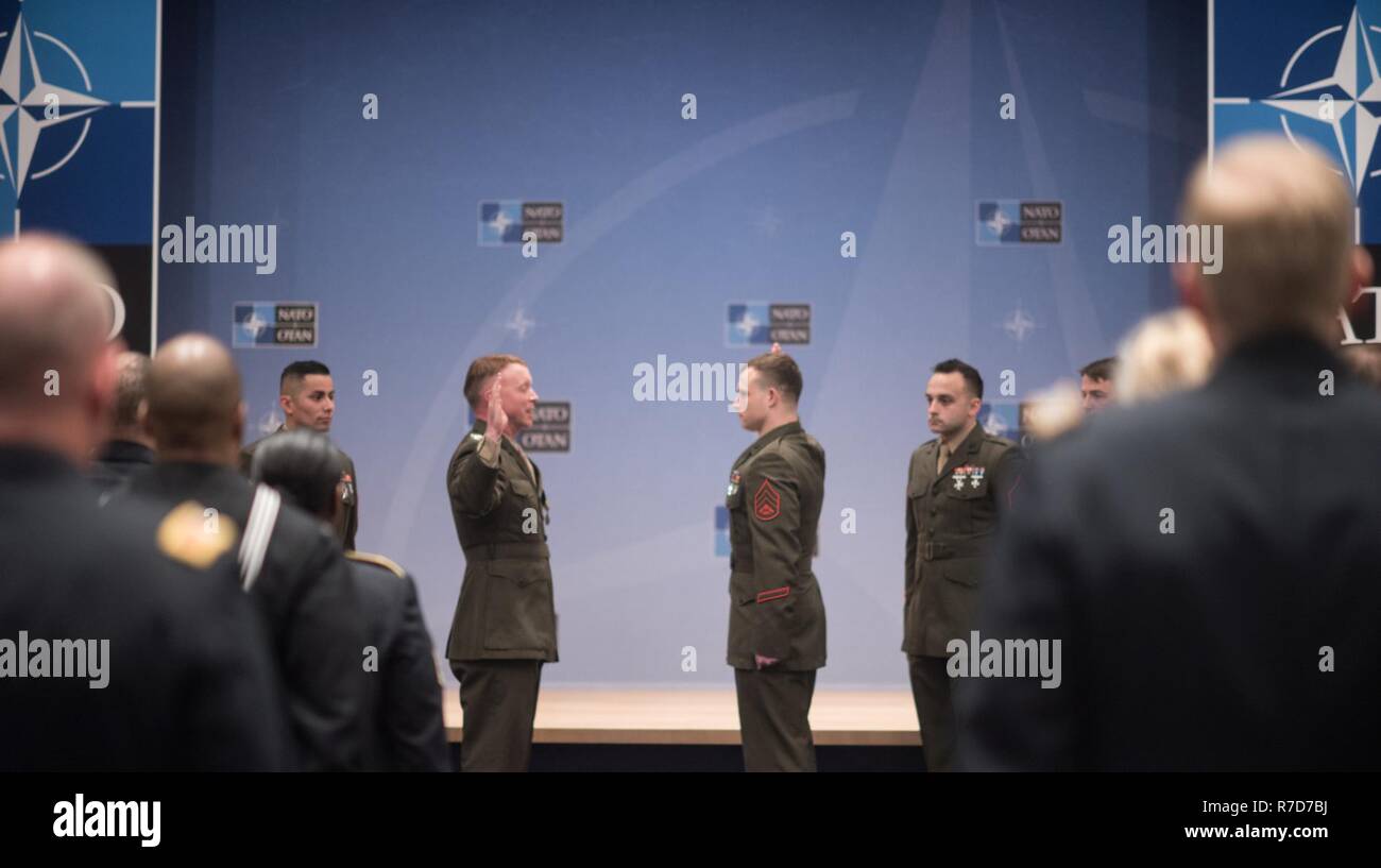 U.S. Marine Col. Philippe Rogers, U.S. Military Delegation to the North Atlantic Treaty Organization (NATO) Chief of Staff, conducts a Re-enlistment ceremony for Staff Sgt. Matthew Leonard, U.S. Marine Guard detachment of the U.S. Embassy to NATO, at NATO Headquarters, May 17, 2017. (DoD Stock Photo