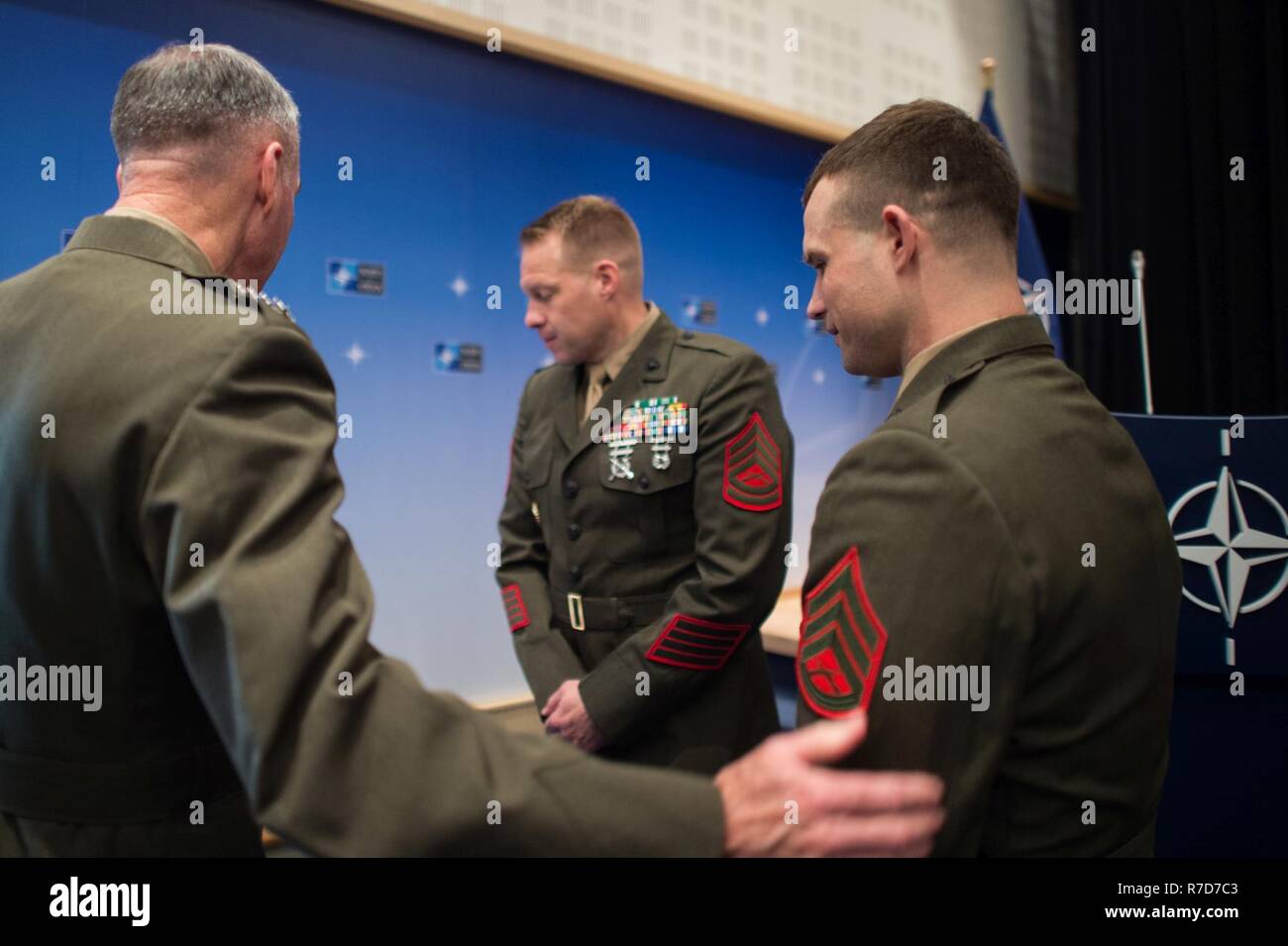 U.S. Marine Corps Gen. Joseph F. Dunford, Jr., chairman of the Joint Chiefs of Staff, congratulates Staff Sgt. Matthew Leonard, U.S. Marine Guard detachment of the U.S. Embassy to NATO, after a Re-enlistment ceremony at NATO Headquarters, May 17, 2017. (DoD Stock Photo