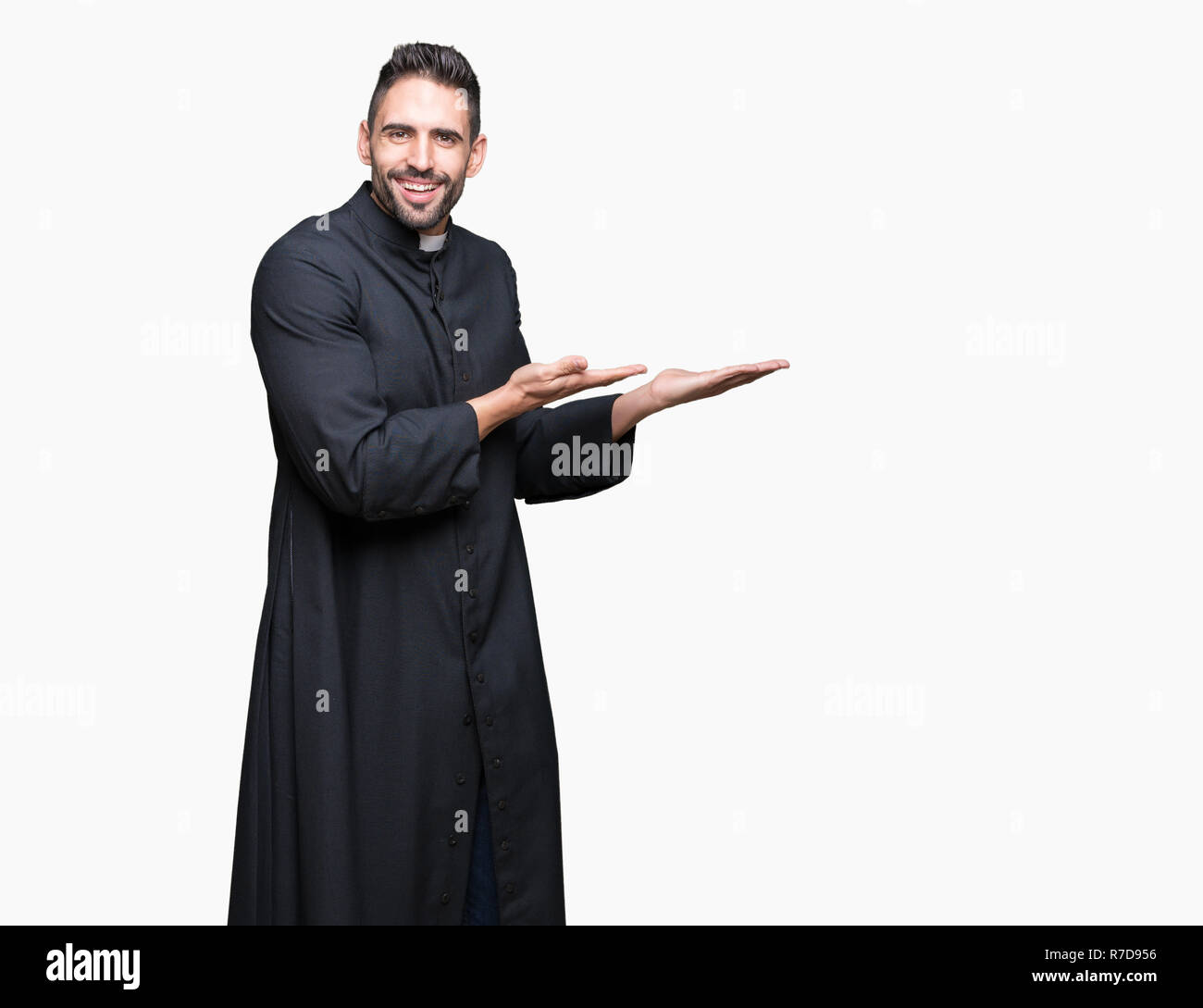 Young Christian priest over isolated background Pointing to the side ...
