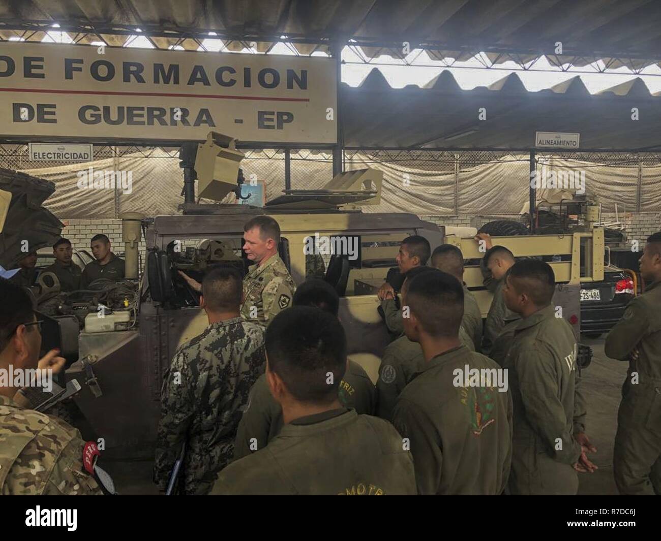 West Virginia Army National Guard (WVARNG) Master Sgt. Ricky Baker and Sgt. 1st Class Joshua Dunlap discuss preventative maintenance checks and services of the M1165 HMMWV Nov. 28, 2018, with Peruvian Army maintenance personnel during a Subject Matter Expert Exchange (SMEE) Global Peace Operations Initiative (GPOI) mission held in Lima, Peru. The WVARNG helped to improve maintenance support for Peru’s Training Center for Peace Operations upcoming mission to the Central African Republic and enhanced non-commissioned officer (NCO) development in their armed forces. Stock Photo