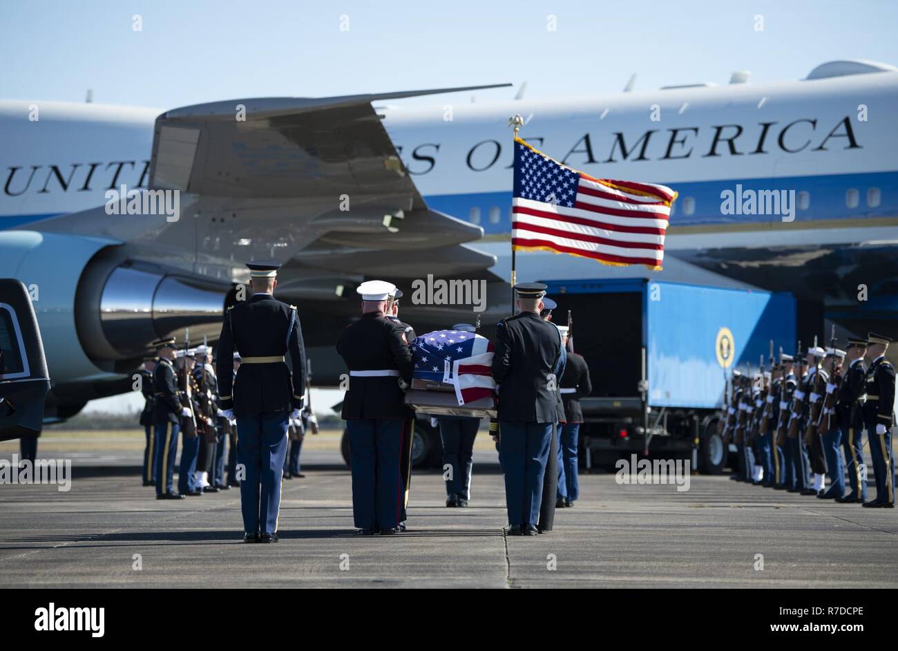 U.S. service members with the Joint Forces Honor Guard carry the casket of former U.S. President George H.W. Bush to an Air Force VC-25 aircraft during a departure ceremony at Ellington Field Joint Reserve Base in Houston, Texas, Dec. 3, 2018. Nearly 4,000 military and civilian personnel from across all branches of the U.S. armed forces, including Reserve and National Guard components, provided ceremonial support during the state funeral of George H.W. Bush, the 41st President of the United States. Stock Photo