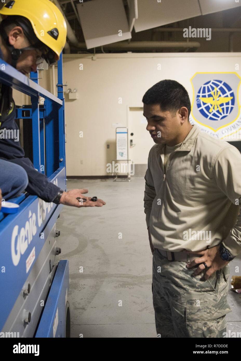 Mr. Mark Bean, a 773d Civil Engineer Squadron heating ventilation air  conditioning refrigeration technician, speaks to Airman Brandon Vaitautolu,  also a 773d CES HVAC/R technician, during a repair job at the Joint