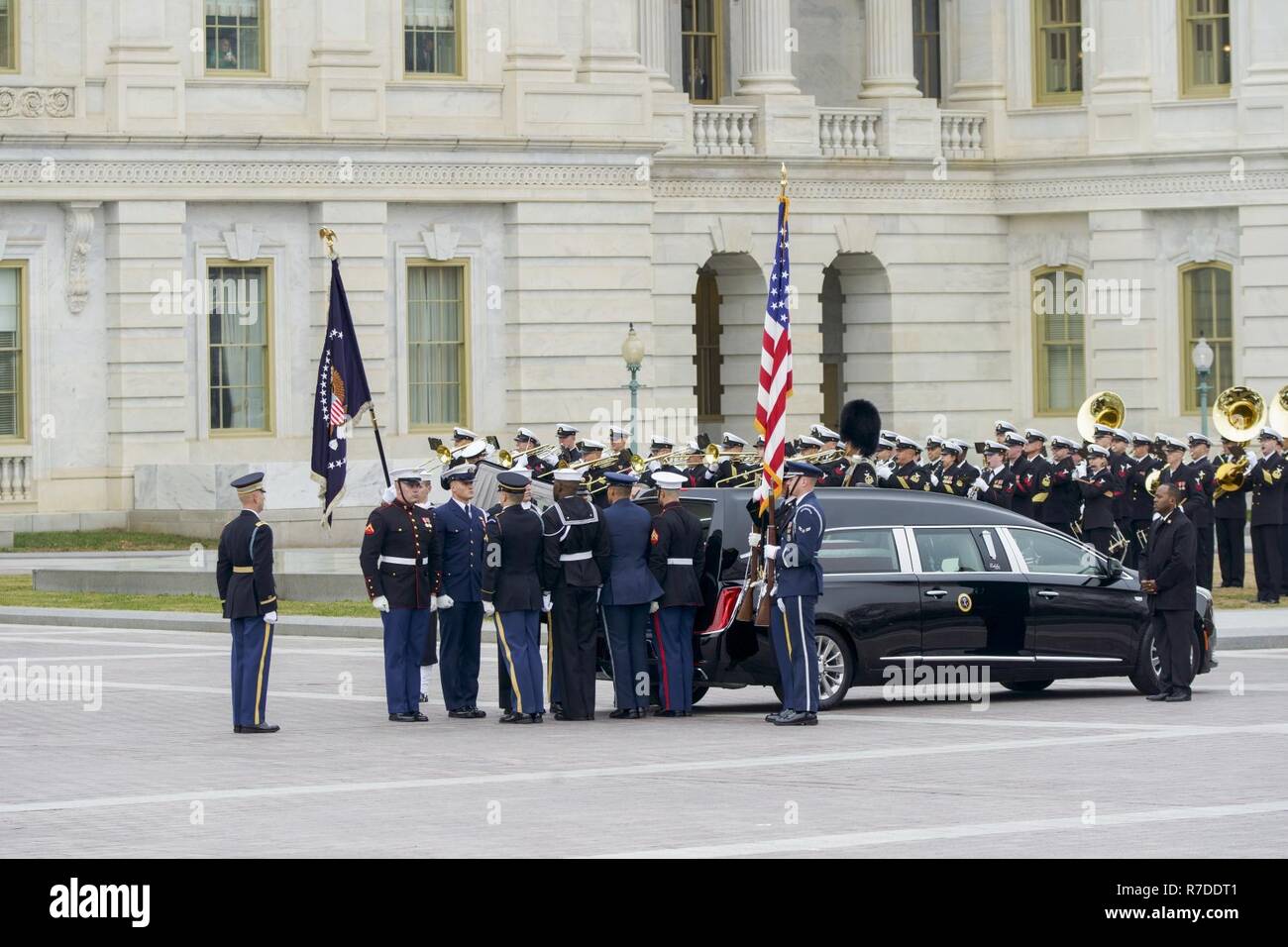 Joint Service Pallbearers representing the United States Army, Navy, Marine Corps, Air Force, and Coast Guard, lay the the flag-draped casket of George H.W. Bush, 41st President of the United States, in a hearse at the United States Capitol, Washington, D.C., Dec. 5, 2018. Nearly 4,000 military and civilian personnel from across all branches of the U.S. armed forces, including Reserve and National Guard Components, provided ceremonial support during George H.W. Bush’s, the 41st President of the United States state funeral. (DoD Stock Photo