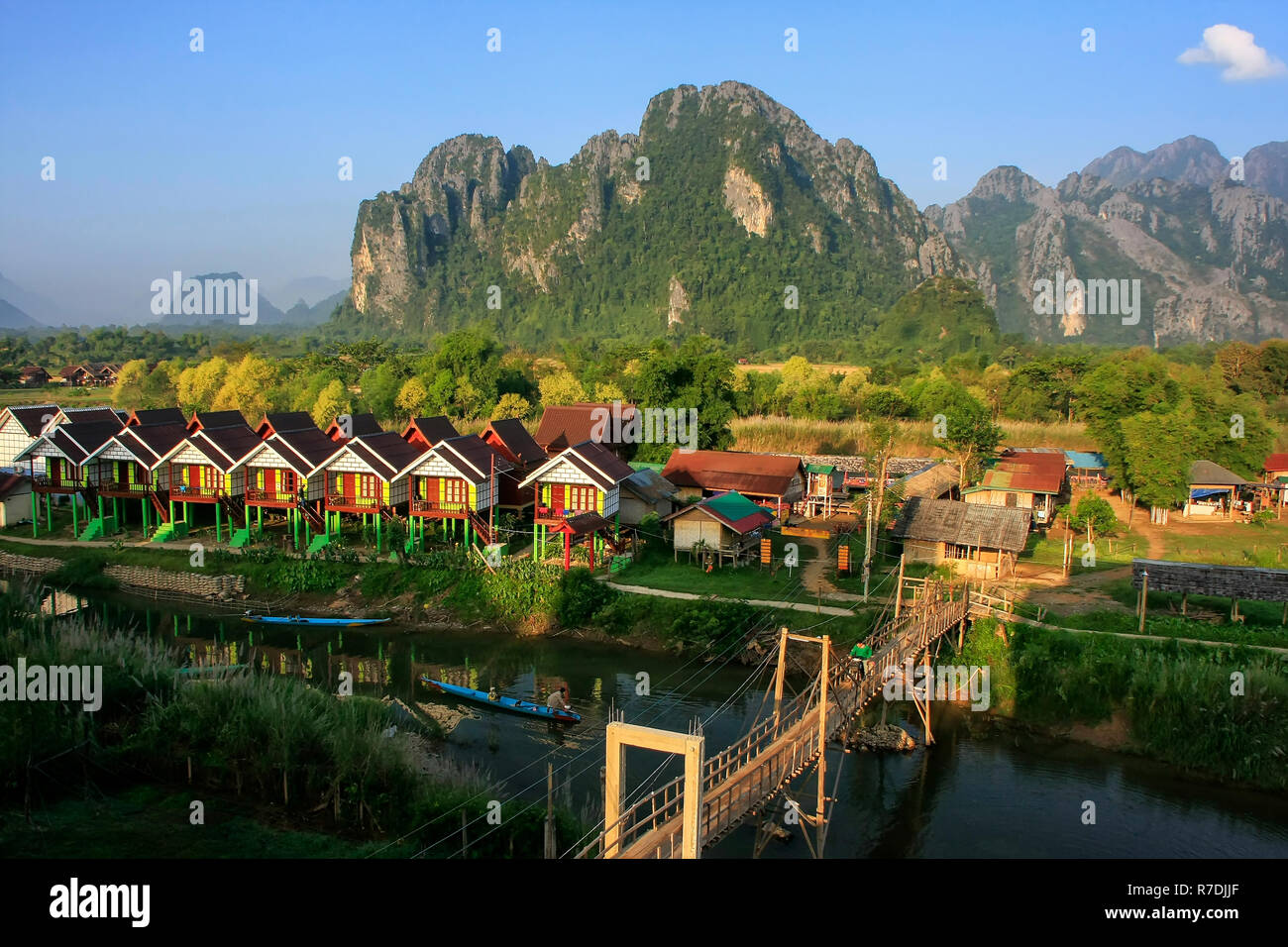 Row of tourist bungalows along Nam Song River in Vang Vieng, Vientiane Province, Laos. Vang Vieng is a popular destination for adventure tourism in a  Stock Photo
