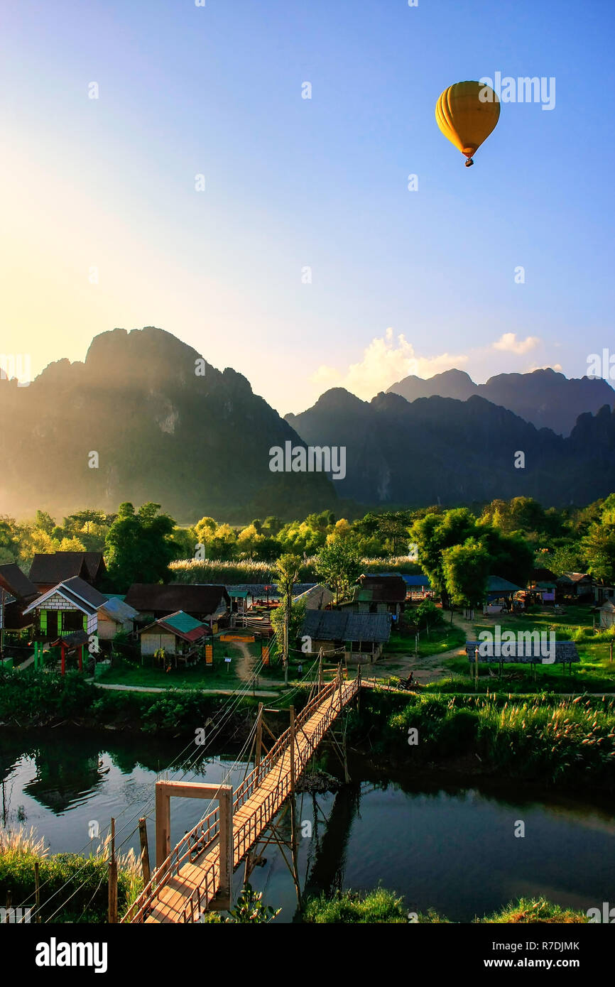 Hot air balloon flying in Vang Vieng, Vientiane Province, Laos. Vang Vieng is a popular destination for adventure tourism in a limestone karst landsca Stock Photo