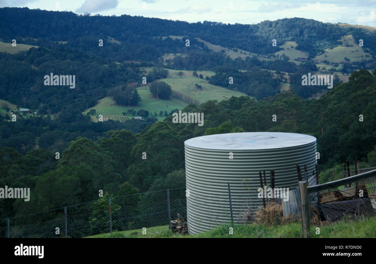 DOMESTIC RAINWATER TANK ON HILLSIDE OF A RURAL PROPERTY IN NEW SOUTH WALES, AUSTRALIA Stock Photo