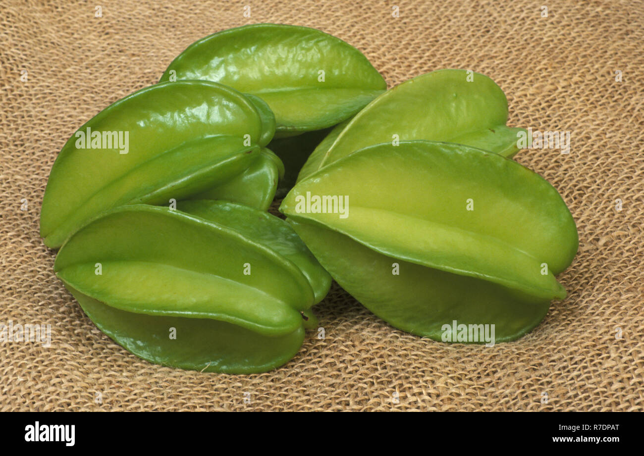 Carambola or starfruit, is the fruit of Averrhoa carambola. The star fruit has five golden-wings that reveal a star-shaped pattern when cut. Stock Photo