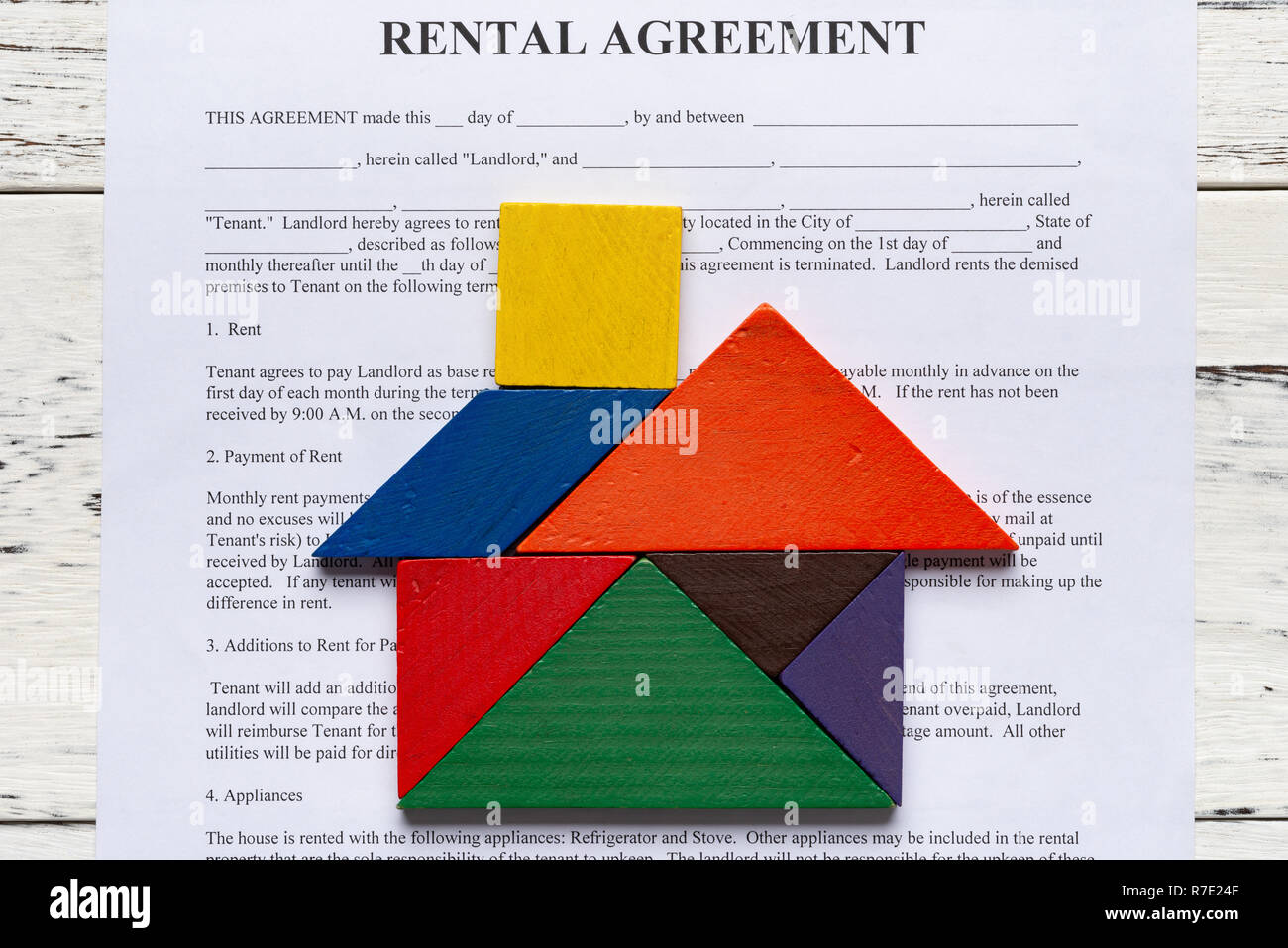 top view rental agreement contact with tangram shaped as a house Stock Photo