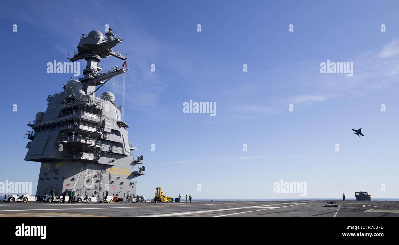 ATLANTIC OCEAN (April 10, 2017) An F/A-18F assigned to the “Salty Dogs” of Test and Evaluation Squadron 23 approaches Pre-Commissioning Unit Gerald R. Ford (CVN 78). The first-of-class ship -- the first new U.S. aircraft carrier design in 40 years -- will spend several days conducting builder's sea trials, a comprehensive test of many of the ship's key systems and technologies. Stock Photo