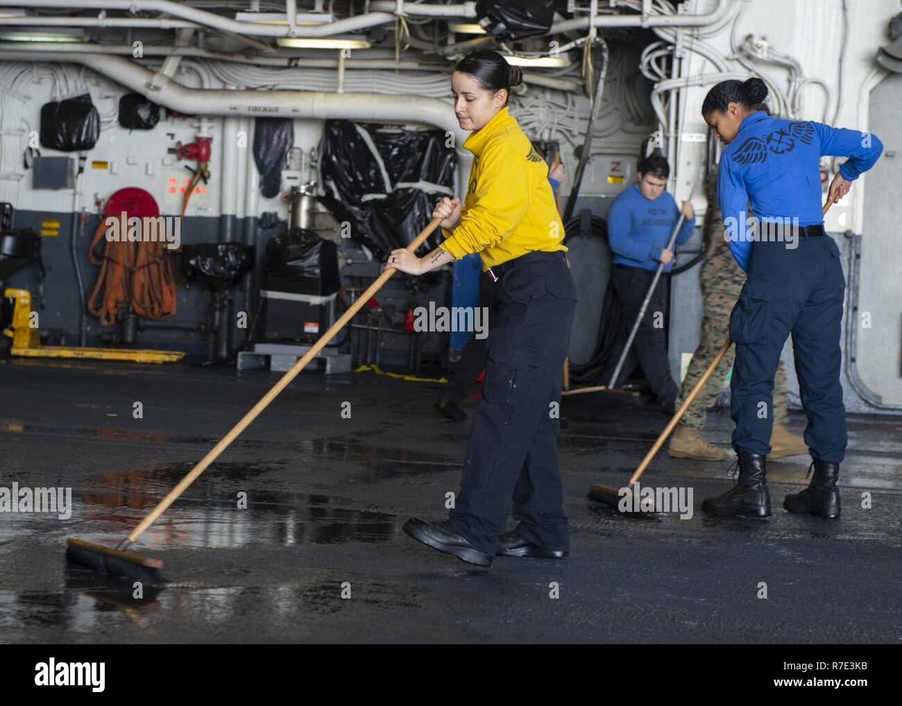 ATLANTIC OCEAN (Nov. 27, 2018) Aviation Boatswain’s Mate (Handling) 3rd Class Alejandra Lozada scrubs the hangar bay of the Wasp-class amphibious assault ship USS Iwo Jima (LHD 7), Nov. 27, 2018. Iwo Jima is currently underway after participating in Trident Juncture 2018 which is a NATO-led exercise designed to certify NATO response forces and develop interoperability among participating NATO Allied and partner nations. Stock Photo
