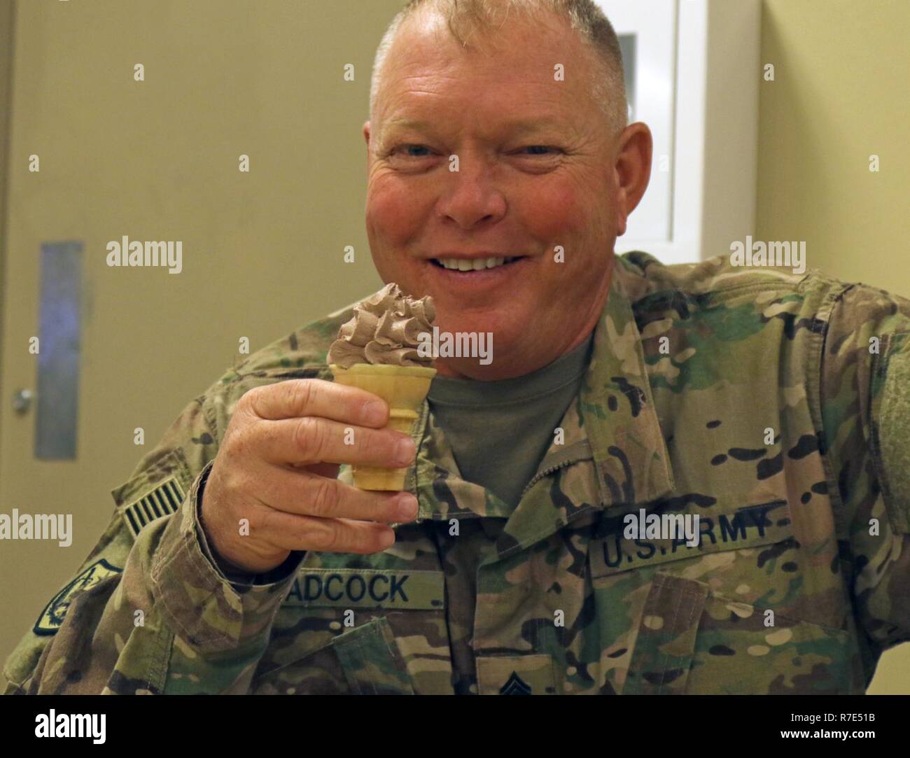Sgt. 1st Class John Adcock, 184th Sustainment Command, enjoys an ice cream cone after his dinner at the dining facility December 1, 2018, at Fort Hood, Texas. The dining facility offers a variety of selections nightly, including a salad bar and an array of desserts. Stock Photo