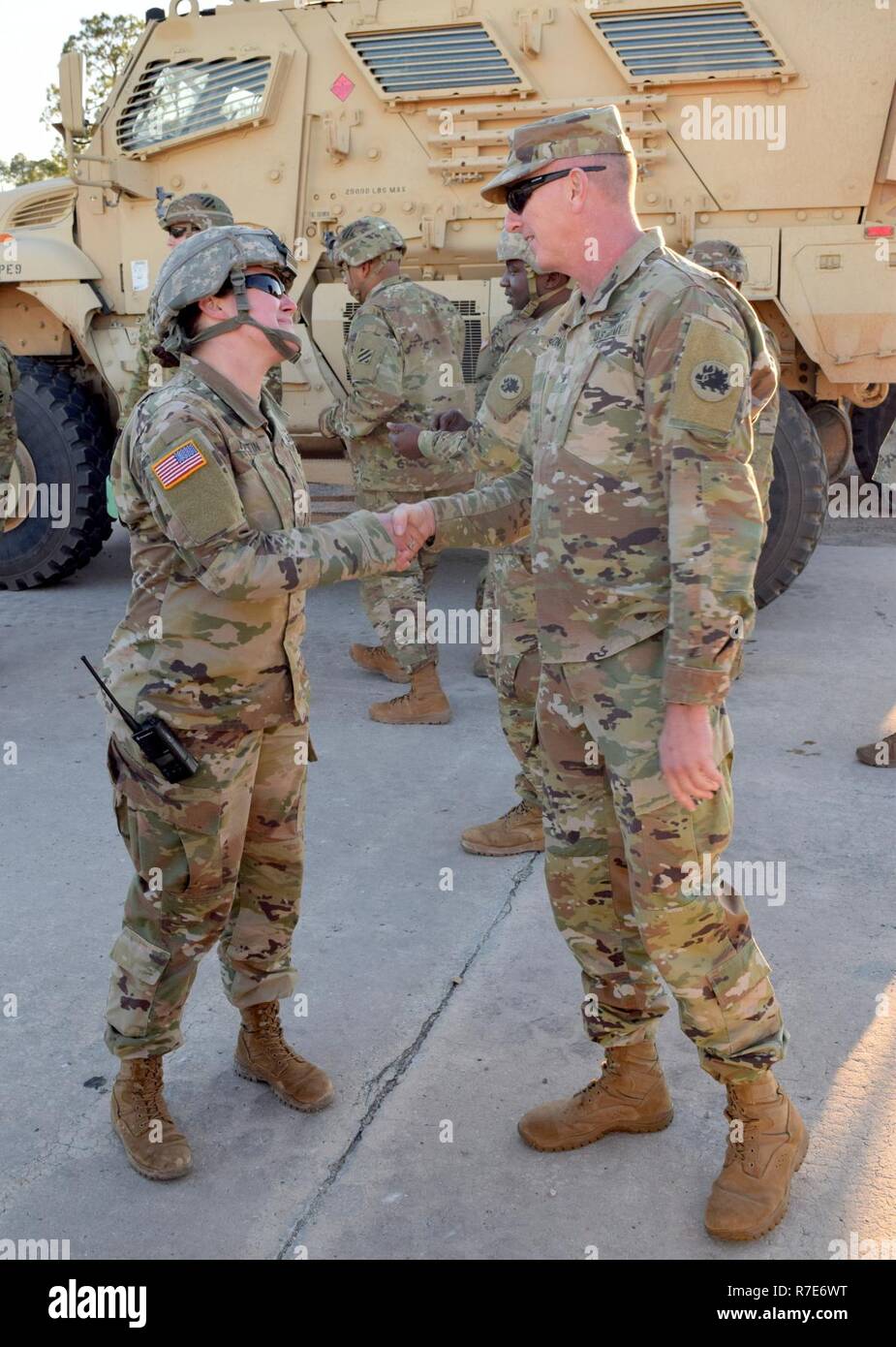 Brigadier General Randall Simmons, commander of the Georgia Army National Guard, presents a coin to Sgt. Asia Martin of the Rome, Ga.-based 1160th Transportation Company Dec 5, 2018 at Fort Stewart, Ga. Sergeant Brown provided drivers training on the MaxxPro mine-resistant ambush-protected vehicle to Soldiers of the 48th Brigade Combat Team. The 48th IBCT is preparing for its fourth combat deployment since September 11, 2001. Stock Photo
