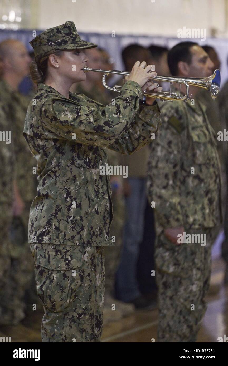 MANAMA, Bahrain (Dec. 5, 2018) Musician 2nd Class Kristen Gale plays “Taps” during a memorial service for Vice Adm. Scott Stearney on Naval Support Activity Bahrain. Vice Adm. Scott Stearney was formerly commander of U.S. Naval Forces Central Command, U.S. 5th Fleet and Combined Maritime Forces. The U.S. 5th Fleet area of operations encompasses nearly 2.5 million square miles of water area and includes the Arabian Gulf, Gulf of Oman, Red Sea and parts of the Indian Ocean. The region is comprised of 20 countries and includes three critical choke points at the Strait of Hormuz, the Suez Canal an Stock Photo