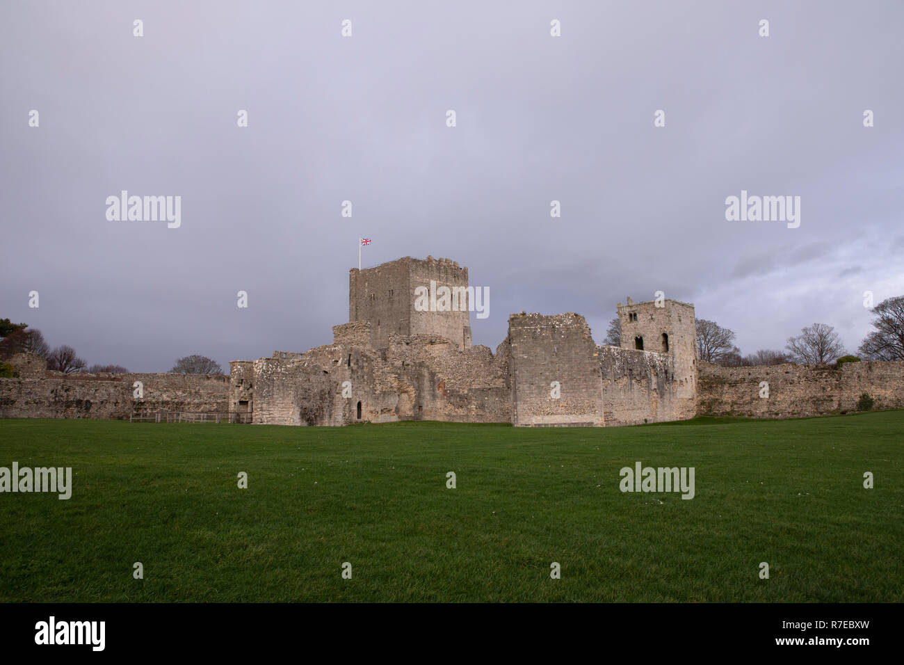 The keep at Portchester castle in Hampshire England. Dark skies behind