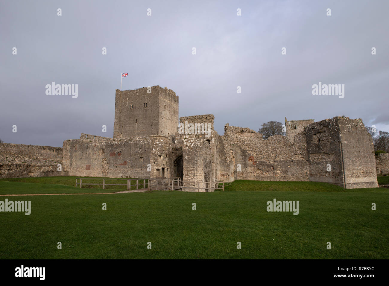 The keep at Portchester castle in Hampshire England. Dark skies behind