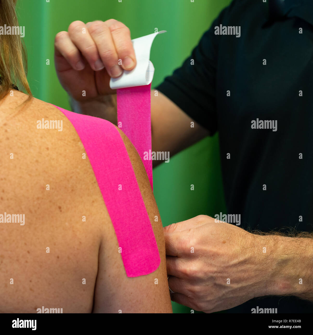 Tape application to the shoulder. A day in the life of a