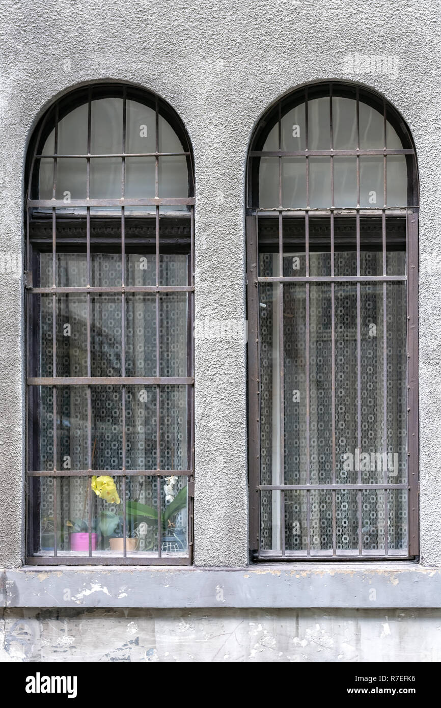 Two windows with an arch and a lattice against a gray wall Stock Photo ...