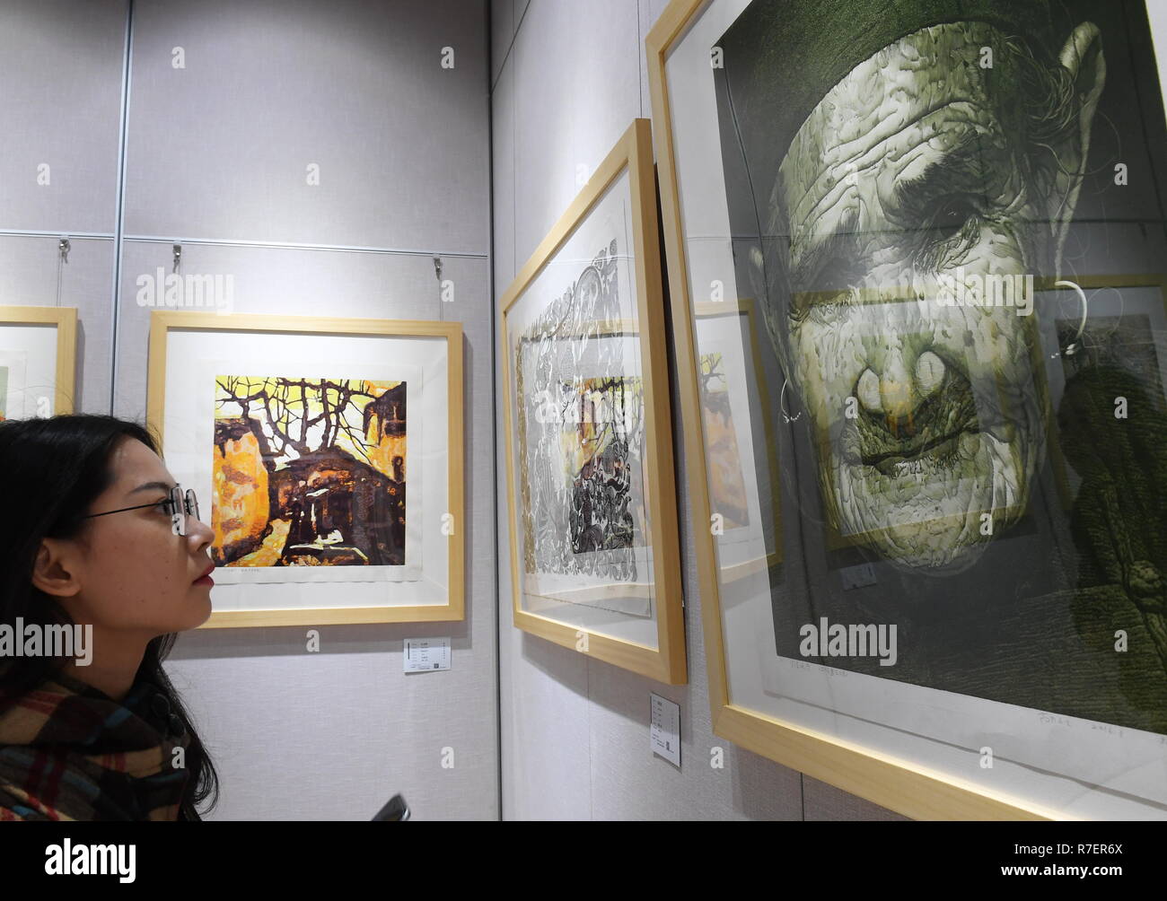 Songxi, China's Fujian Province. 9th Dec, 2018. A visitor looks at artworks of wood prints in Songxi County, southeast China's Fujian Province, Dec. 9, 2018. Local folk artists of wood printing have devoted to the promotion of the traditional art form in recent years. Credit: Zhang Guojun/Xinhua/Alamy Live News Stock Photo