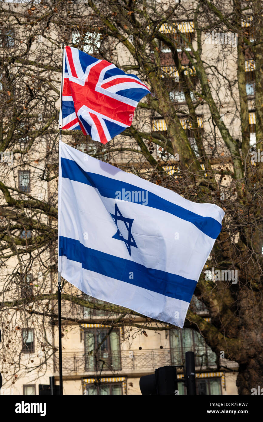 Brexit Betrayal march. Protesters are demonstrating at what they see as a betrayal by the UK government in not following through with leaving the EU in its entirety after the referendum. Star of David flag of Israel and Union Jack flag Stock Photo