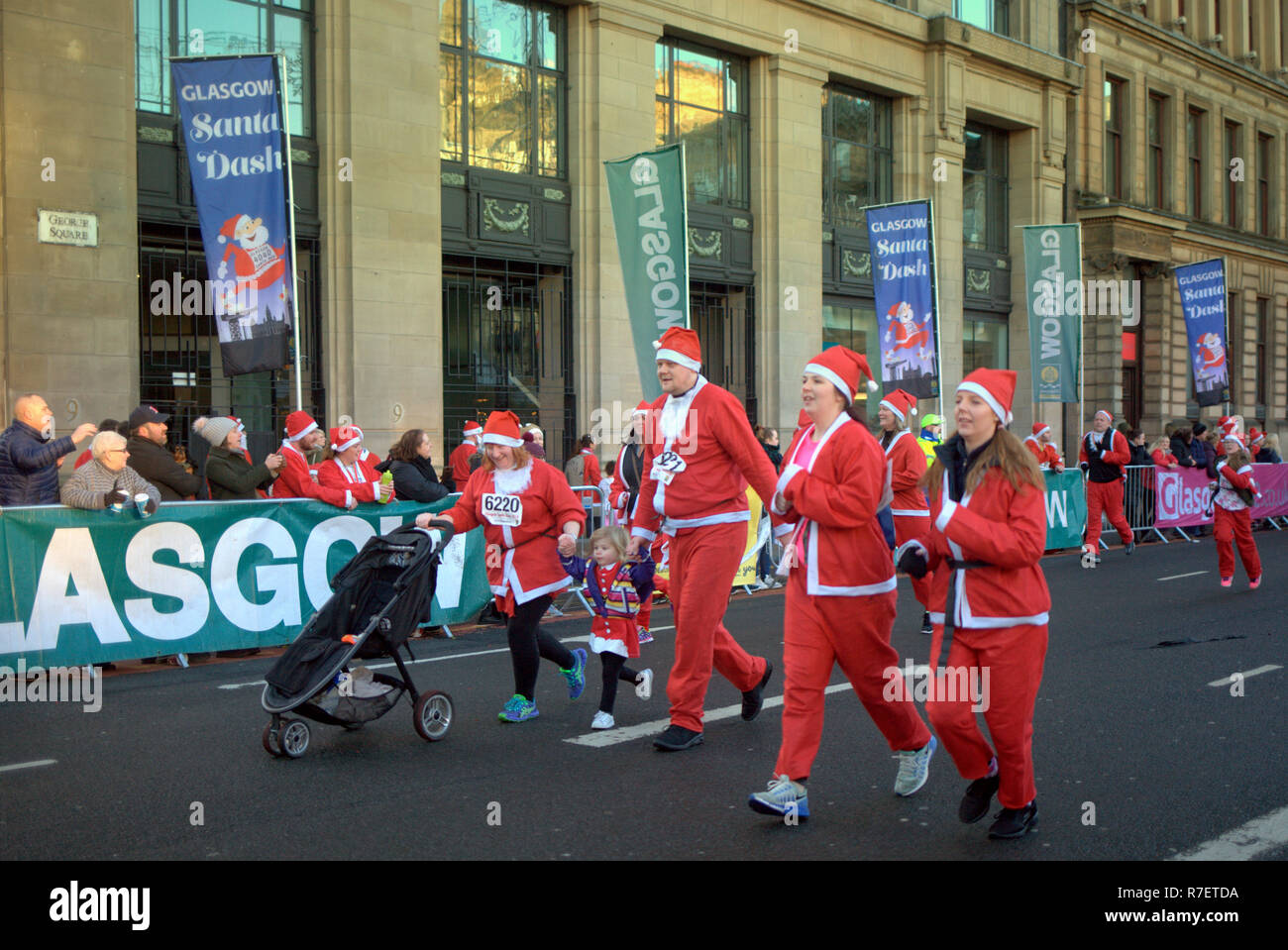 Glasgow, Scotland, UK, 9th December. Santa Dash Sunday saw the start and finish in the centre of the city in George as the Santas ran down the home straight to then party in the Christmas market  Square. Credit Gerard Ferry/Alamy news Stock Photo