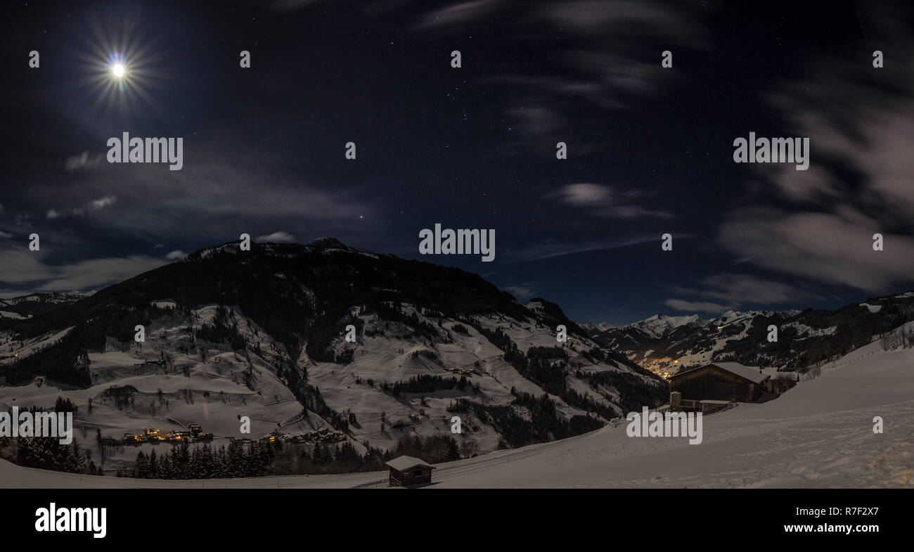 Winterliche Vollmondnacht über dem Grossarltal Stock Photo