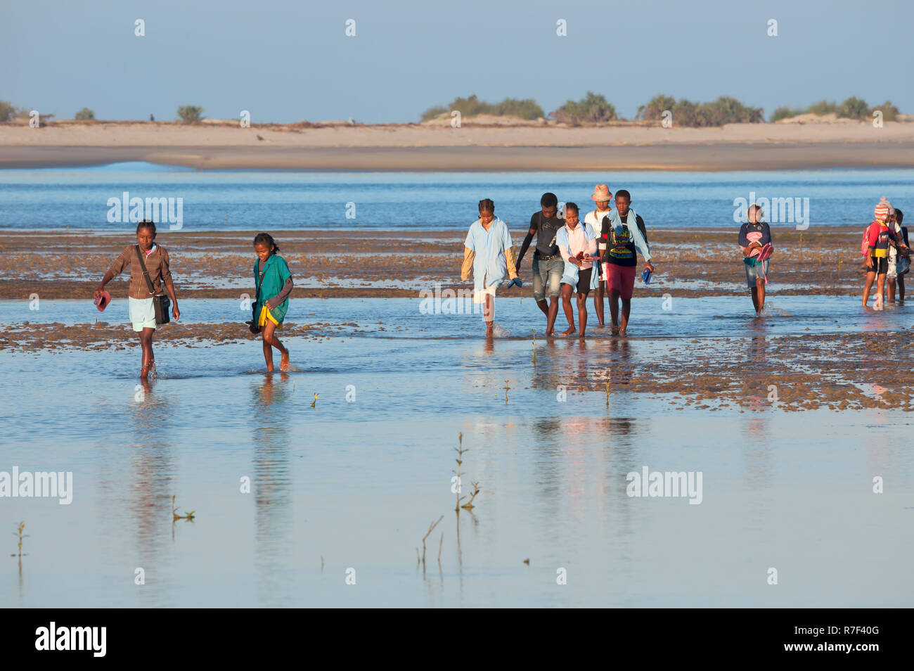 Malagasy people crossing the water, Morondava, Toliara province, Madagascar Stock Photo