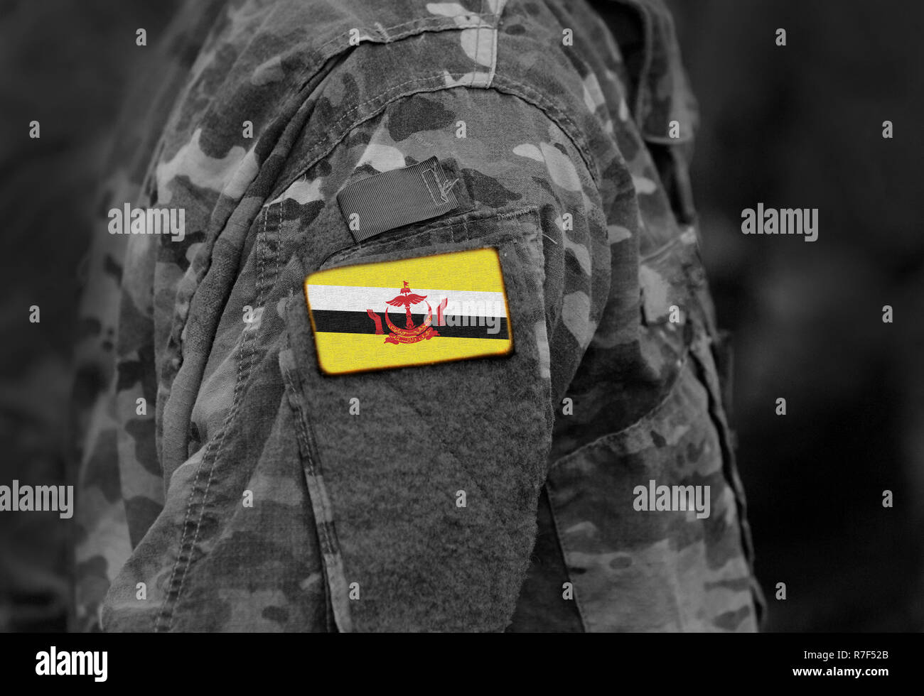 Flag of Brunei on soldiers arm. Flag of Brunei on military uniforms (collage). Stock Photo