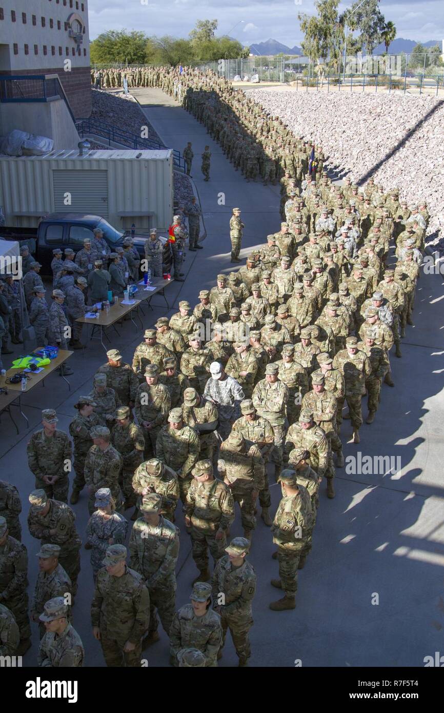 More than 3,800 National Guard Soldiers and Airmen prepare to march onto the field during the 2018 Arizona National Guard Muster December 2 at the Kino Sports Complex in Tucson, Ariz. The Muster, which traces its roots to the original formation of state militias in the 1600's, is held once every four years as a means of connecting Arizona guardsmembers with the communities they serve. The event featured a pass and review of the guardmembers, a community exposition, and concert by the 108th Army band and local band Black Horse Arizona. Stock Photo