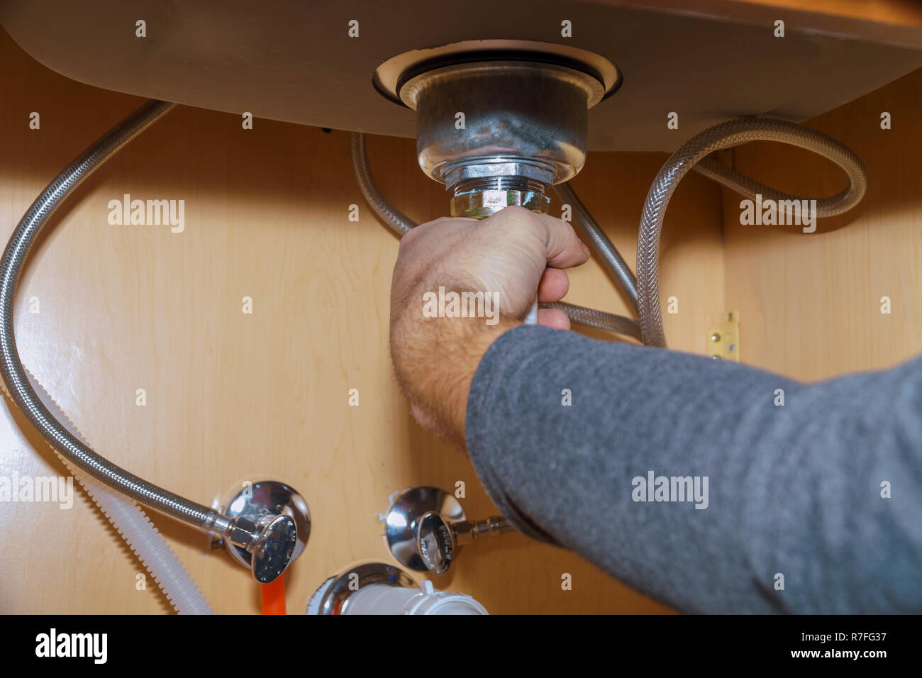 Plumber Install a Sink In kitchen Stock Photo