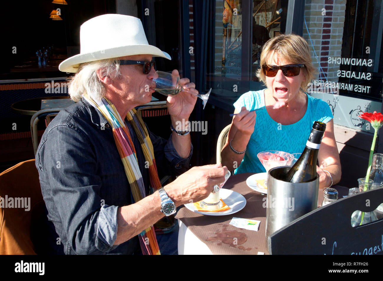 Mature couple lunching al fresco in Honfleur, Normandy Stock Photo