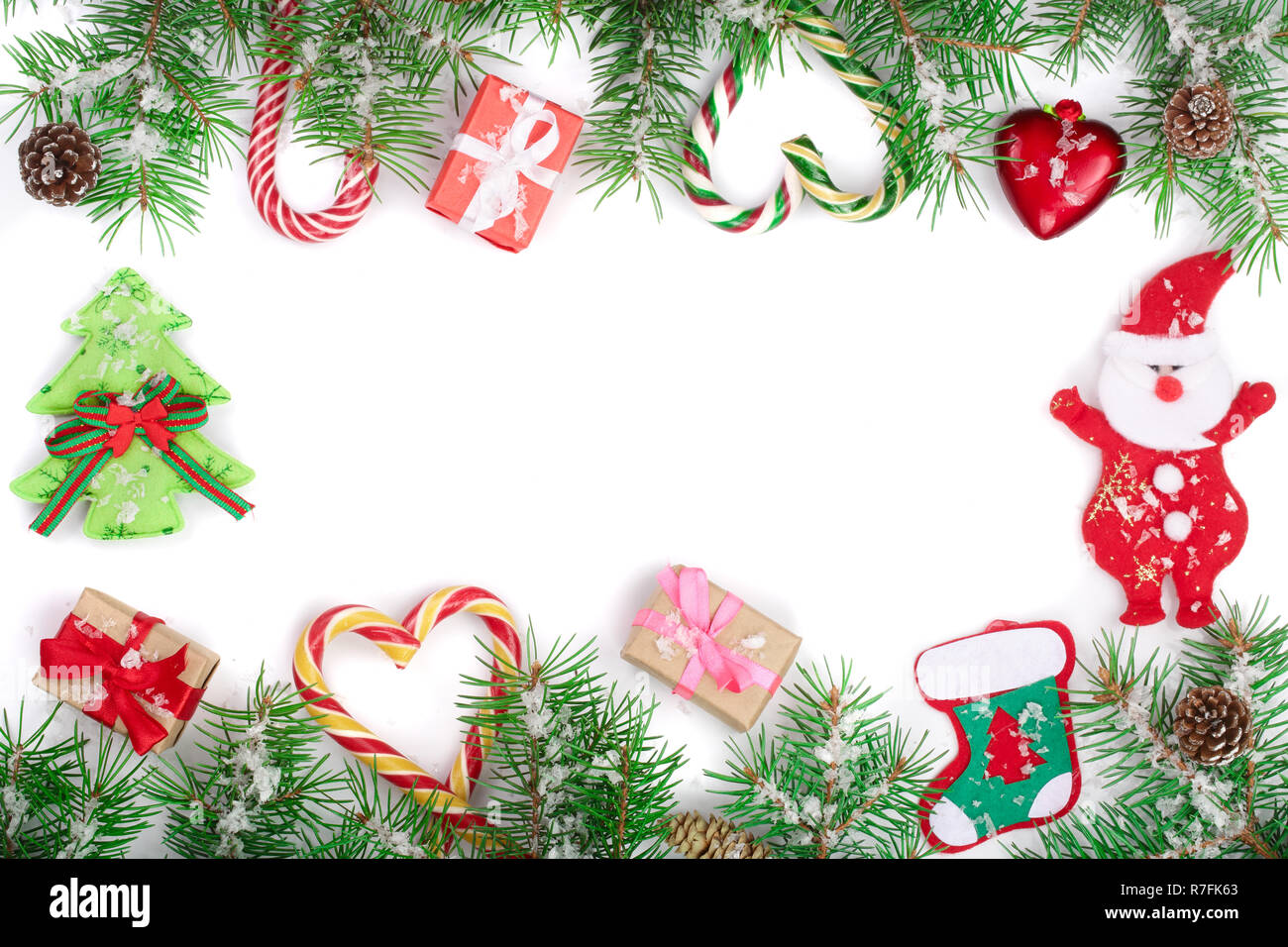 Christmas Frame of Fir tree branch with candy canes and boxes isolated ...