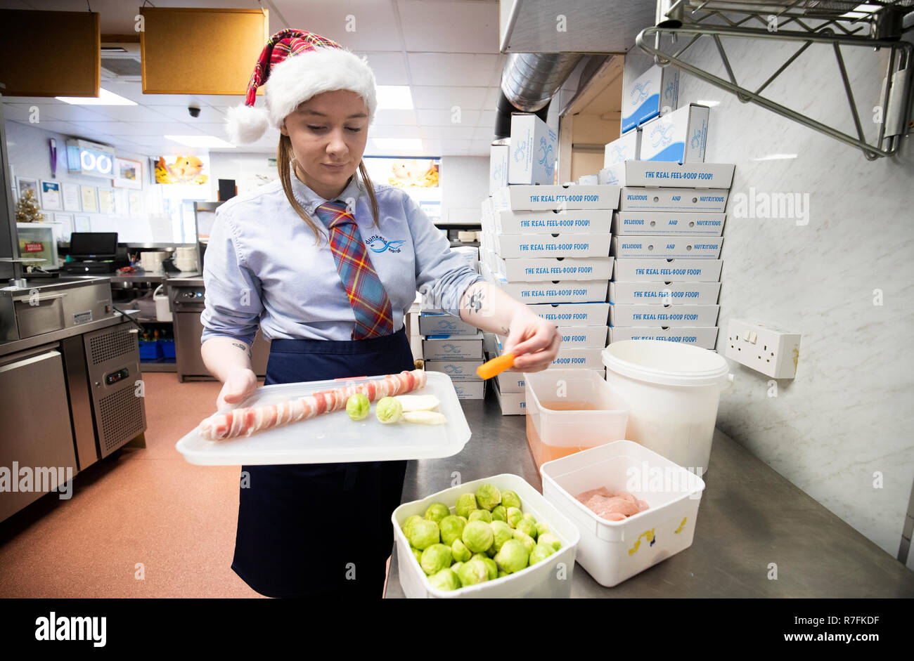 Chelsea McGowan prepares a Christmas dinner for deep frying at Dunkeld Fish Bar in Dunkeld, Perthshire. Stock Photo