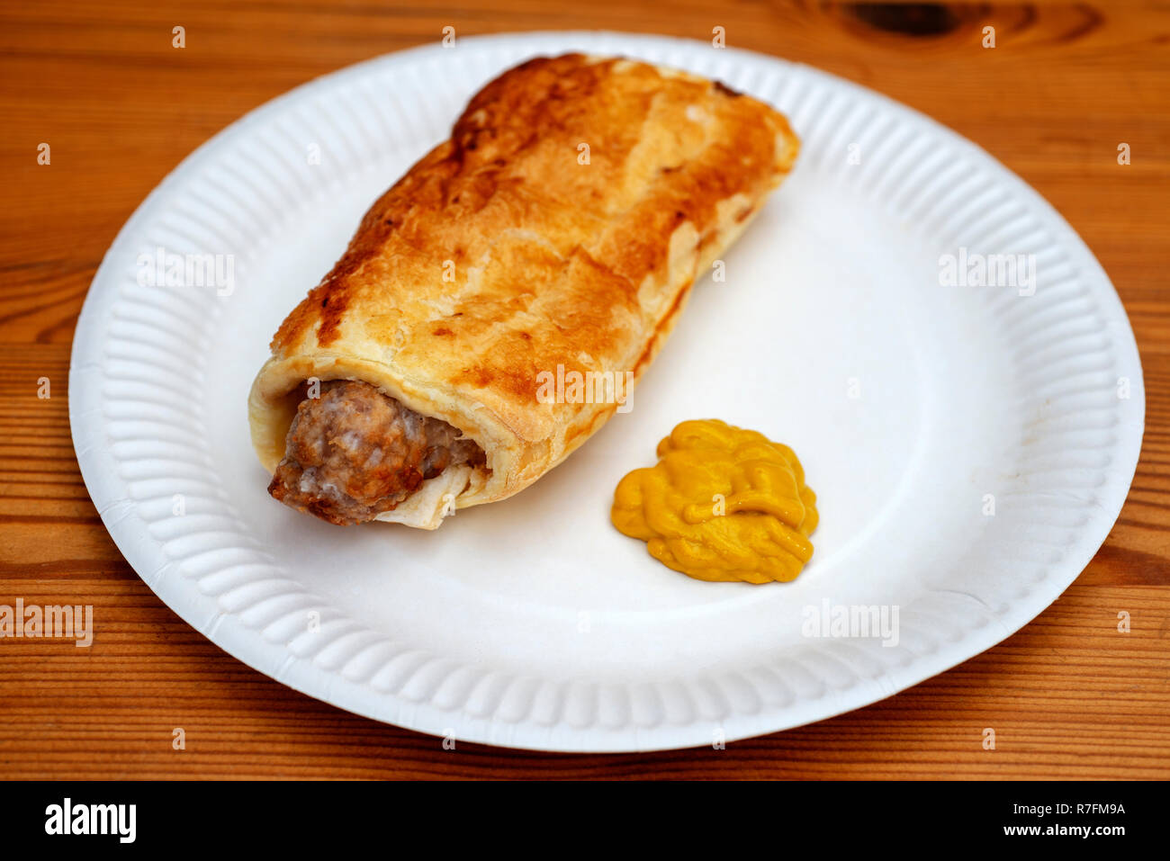 Homemade sausage roll with English mustard Stock Photo