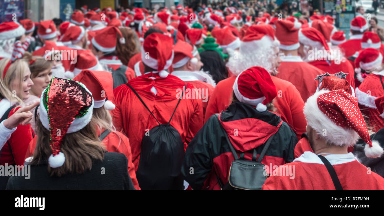 London, UK - December 2018 : Group of people dressed in santa outfits ...