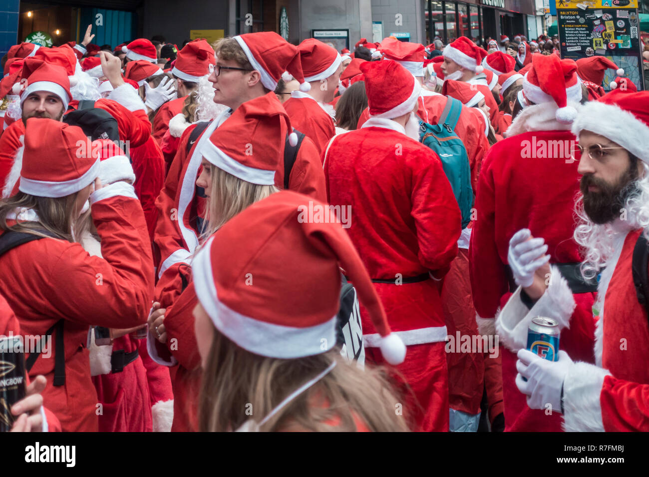 London, UK - December 2018 : Group of people dressed in santa outfits ...