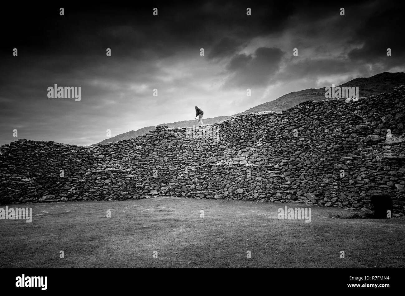 Girl running over the Staigue stone fort, a defensive stronghold built during the iron Age in Sneem, Ireland Stock Photo