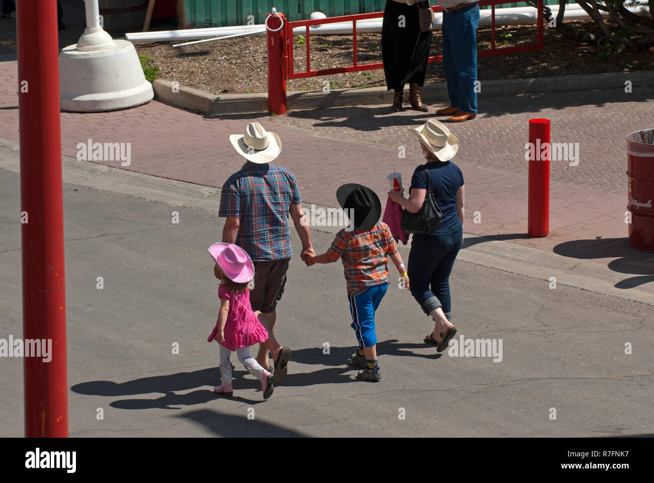 A family walking in Stampede Park during Calgary Stampede show, Calgary
