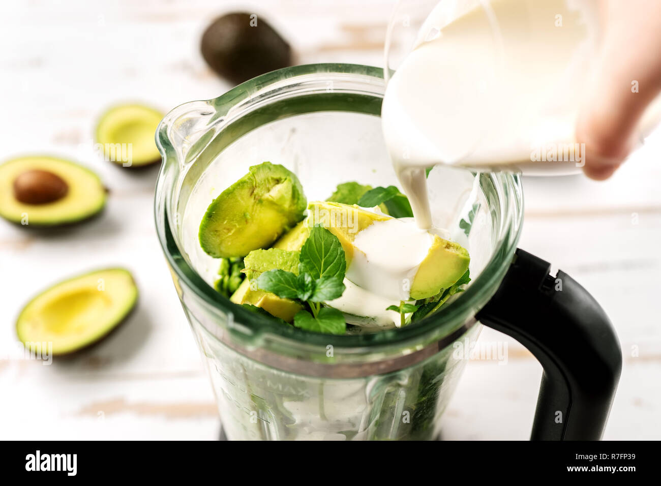 Top view of blender with avocado peaces Stock Photo